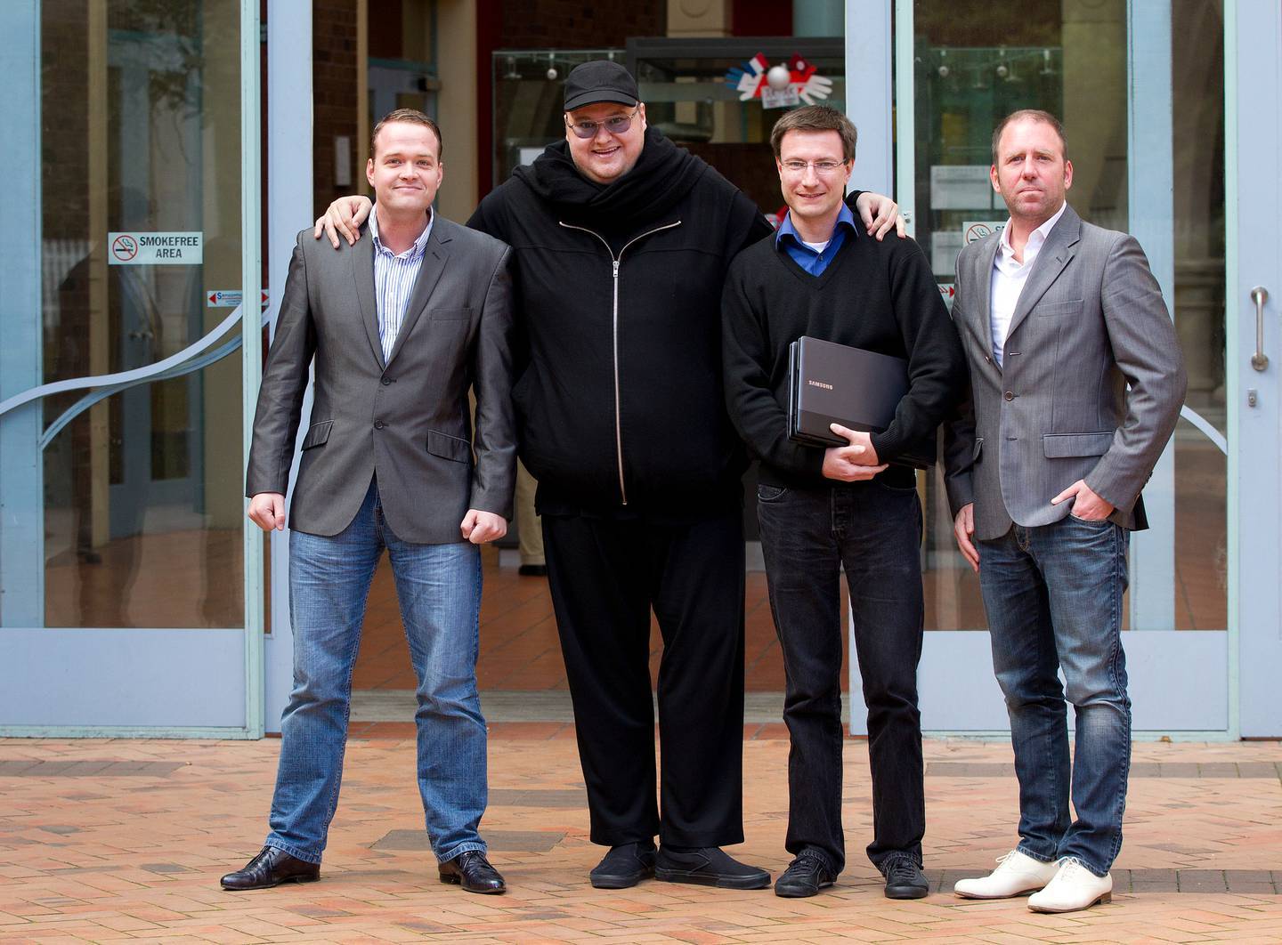 Bram Van der Kolk, Kim Dotcom, Mathias Ortmann and Finn Batato outside the Auckland High Court in 2012, the year of the Megaupload raid. Photo / File