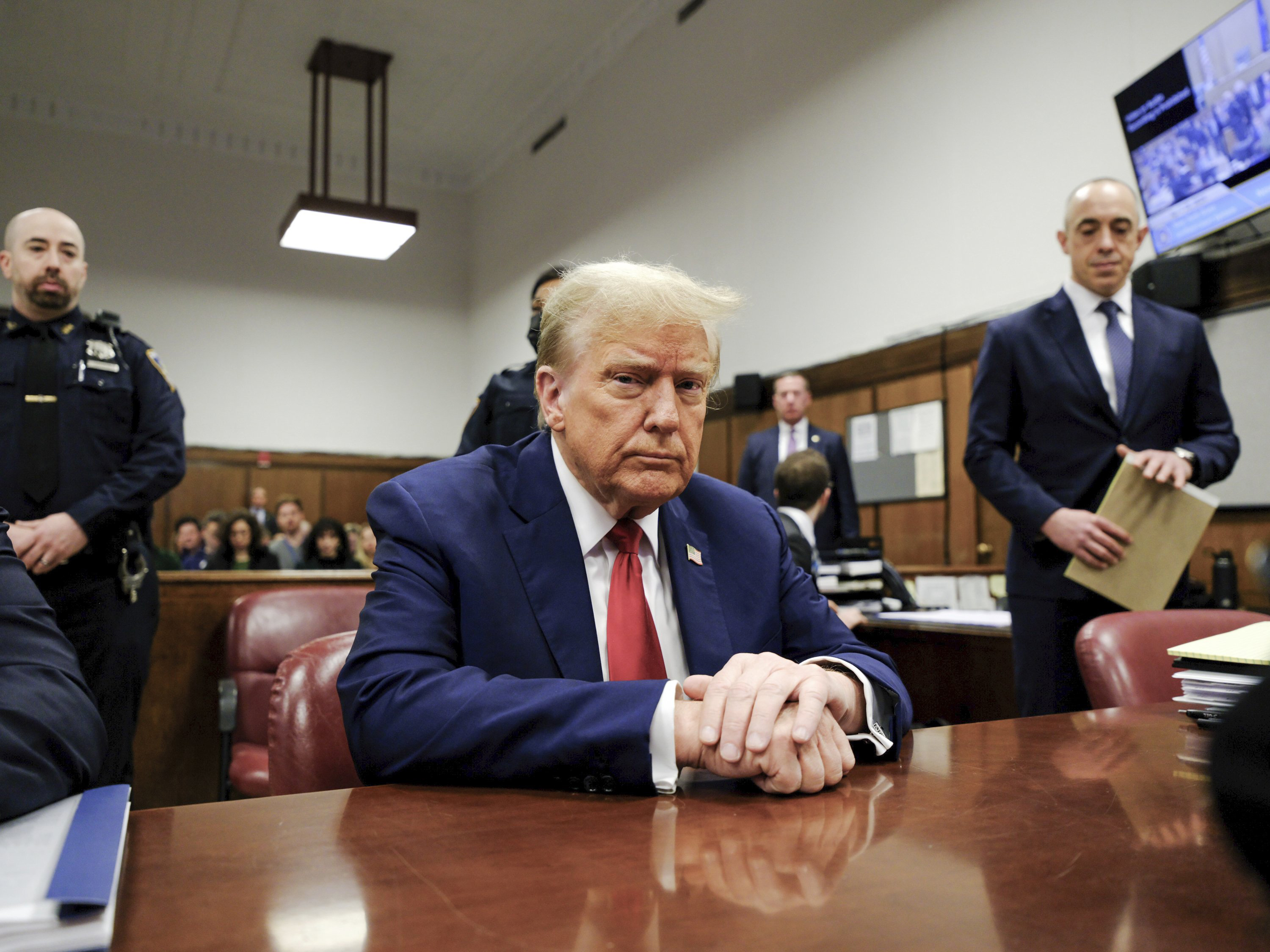Donald Trump listening in court as his lawyer was upbraided by the judge. Photo / AP