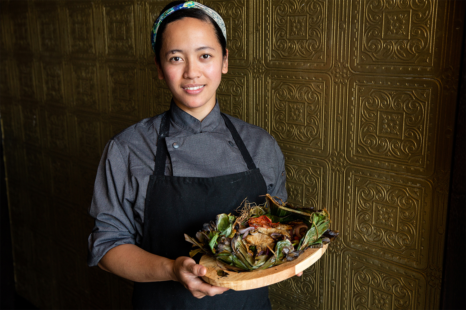 Jessabel Granada with her dad's sugba grilled fish dish. Photo / Babiche Martens.