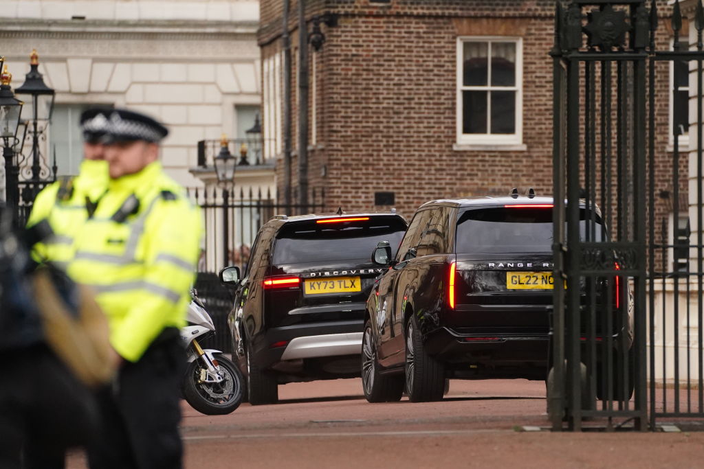Two black SUVs, believed to be carrying Prince Harry, arrive at Clarence House, London, following the announcement of the King's cancer diagnosis on Monday evening. Photo / Getty