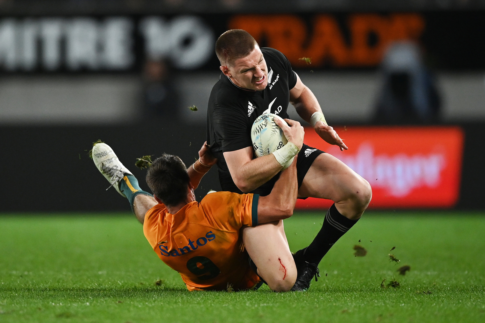All Blacks player Jordie Barrett is tackled by Wallabies player Jake Gordon during Saturday's test at Eden Park. Photosport