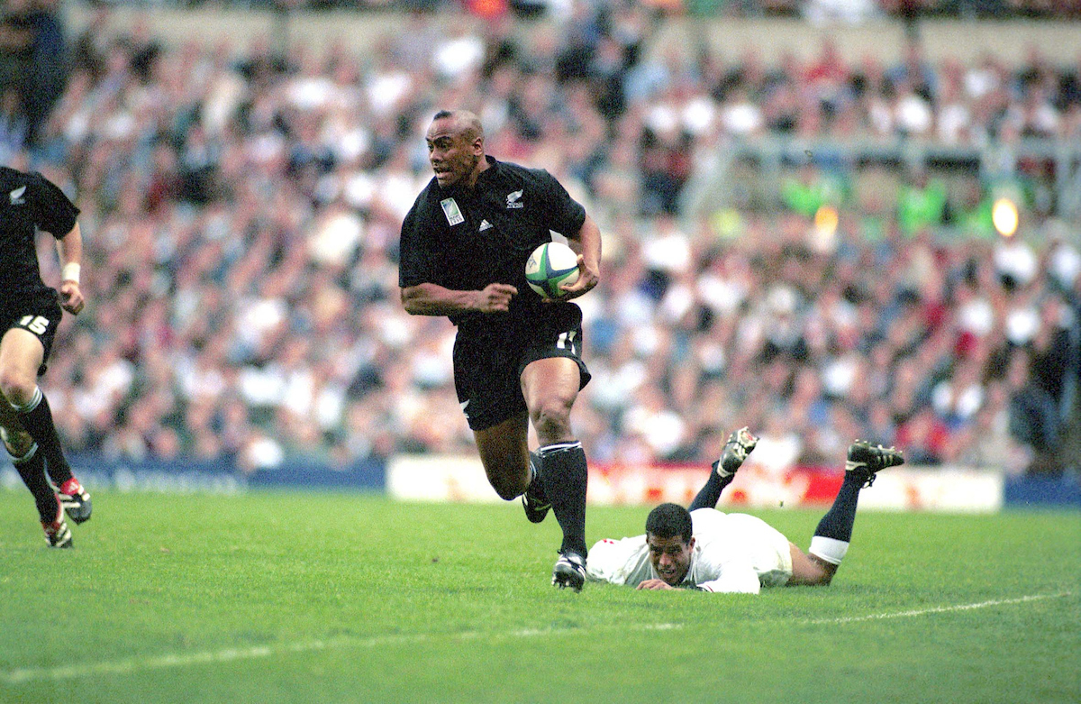 Jonah Lomu breaks the tackle of Jeremy Guscott during the 1999 World Cup clash with England. Photosport