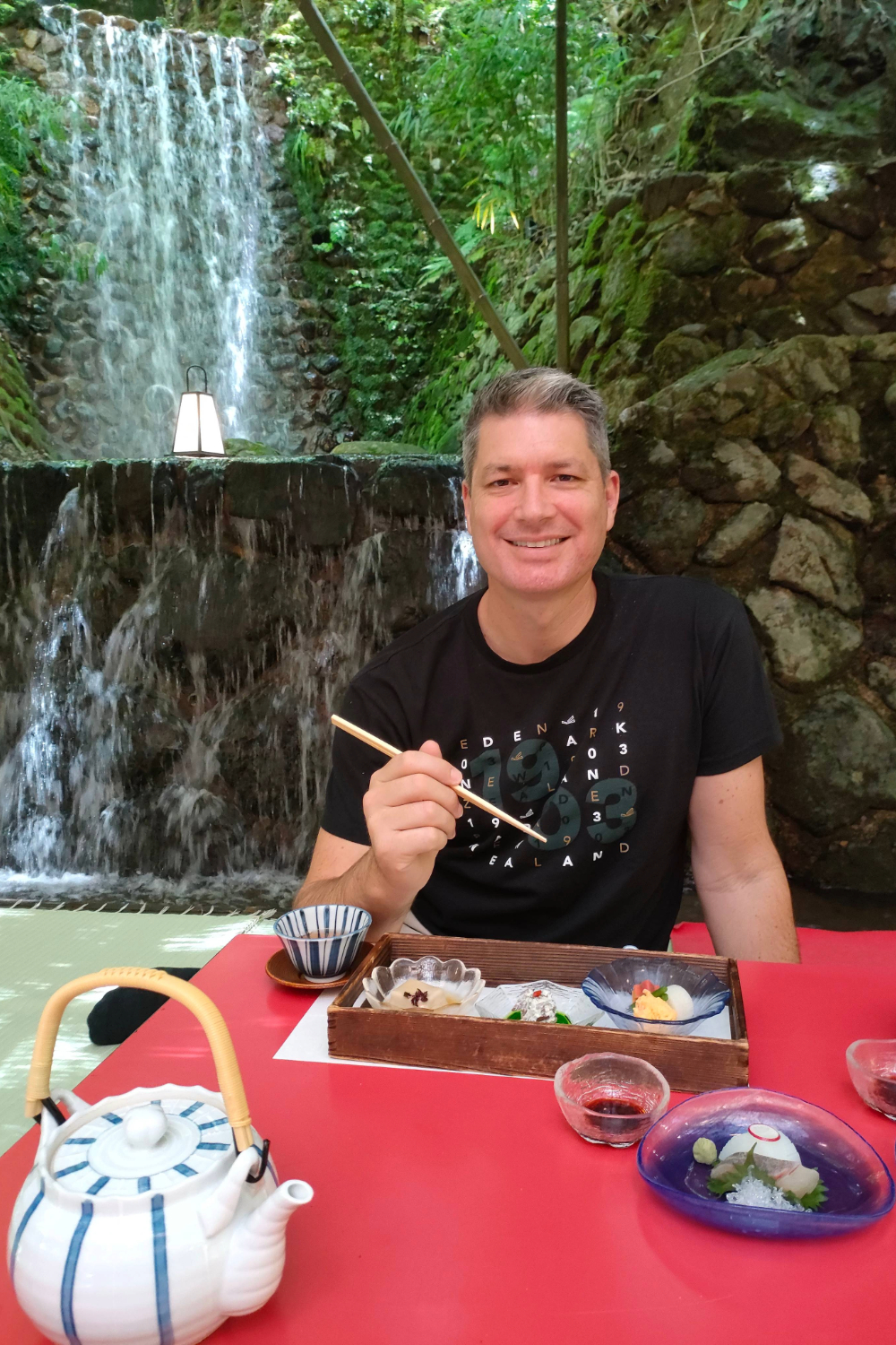 Jesse Mulligan enjoys lunch at a table set above a river at Beniya in Kibune, just outside of Kyoto.