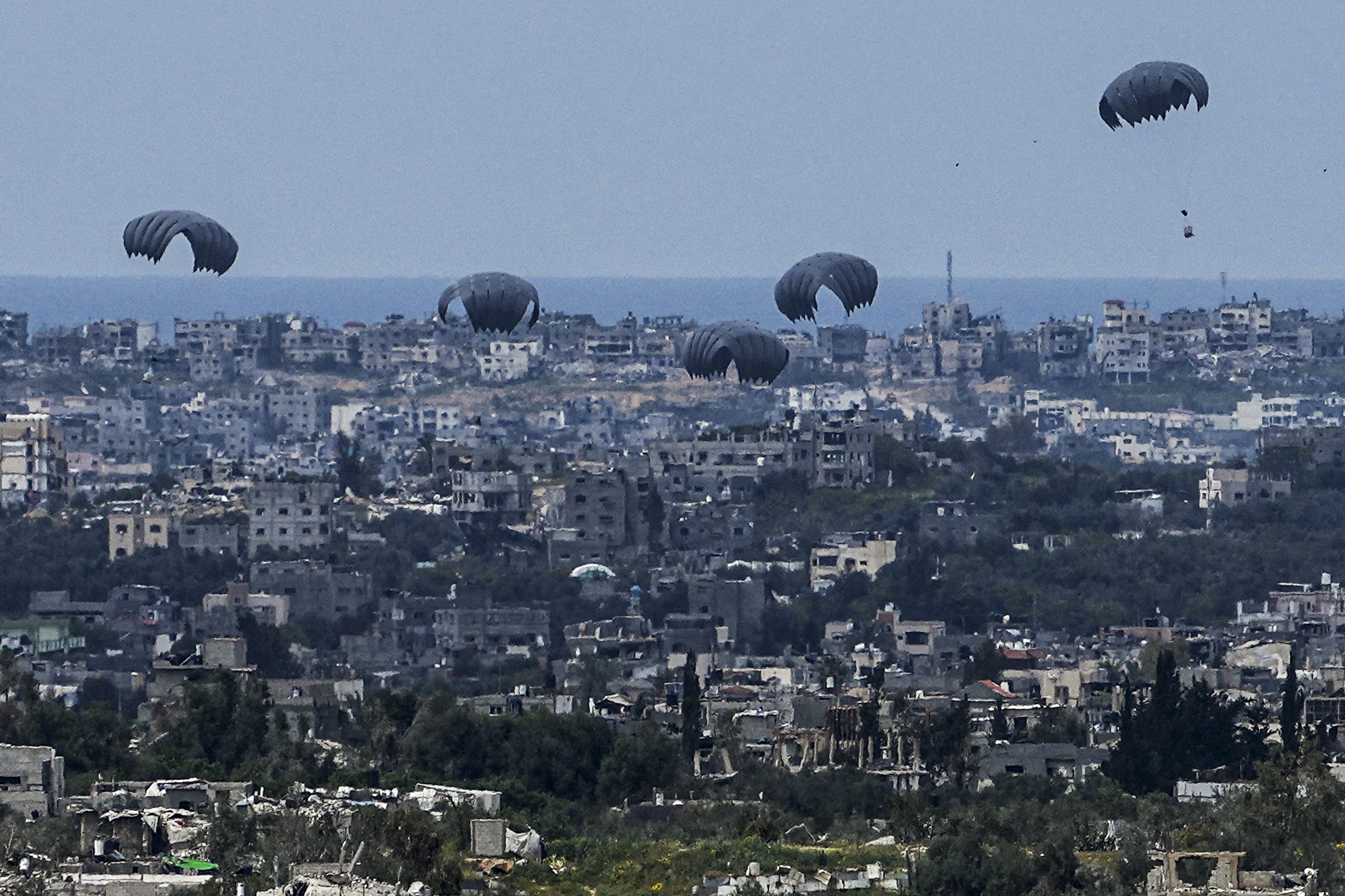 Parachutes drop supplies into the northern Gaza Strip, as seen from southern Israel, Sunday, March 24, 2024. Photo / AP