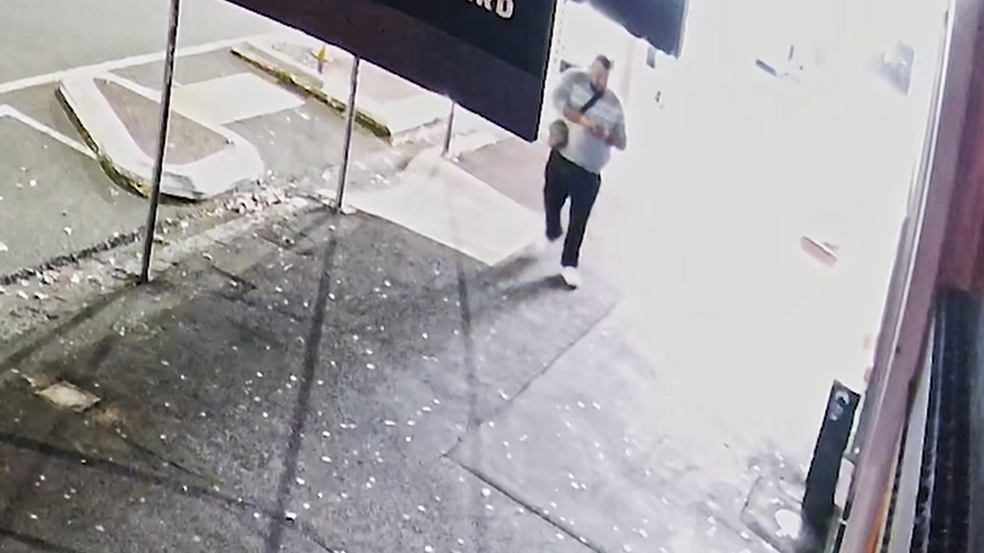 The man wanted by police in relation to the Ponsonby Rd shooting can be seen looking at his cellphone in the immediate aftermath of the shooting.