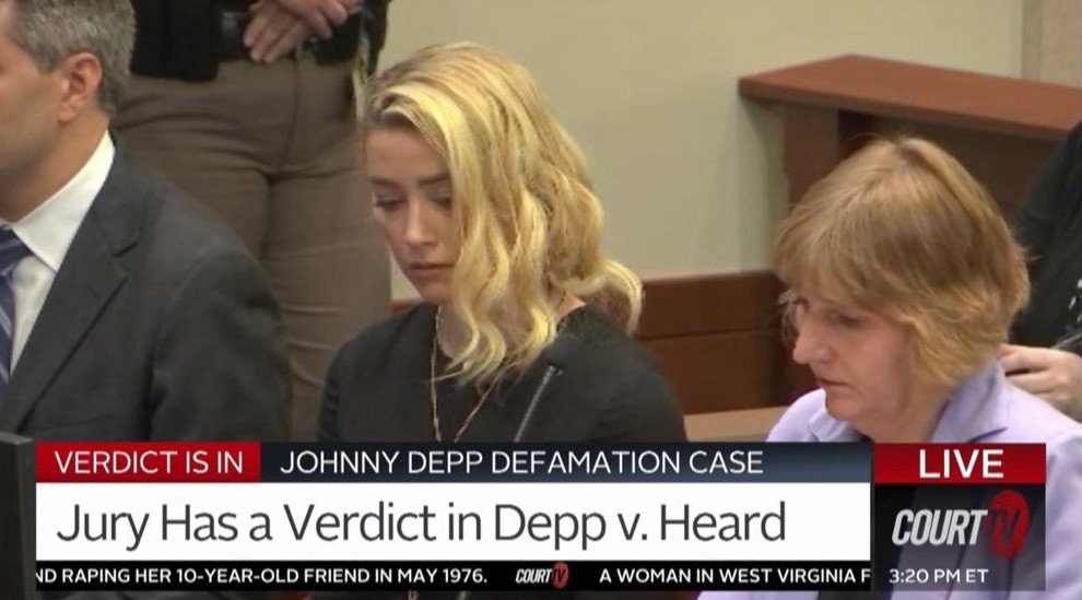 Amber Heard reacts, with her lawyer Elaine Bredehoft at as the verdict is read in the courtroom. Photo / Court TV via AP