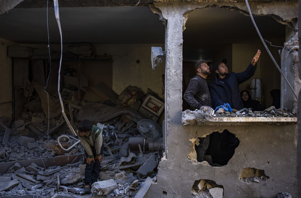 Palestinians look at the destruction after an Israeli strike in Rafah, southern Gaza Strip, Thursday, Feb. 8, 2024. (AP Photo/Fatima Shbair)