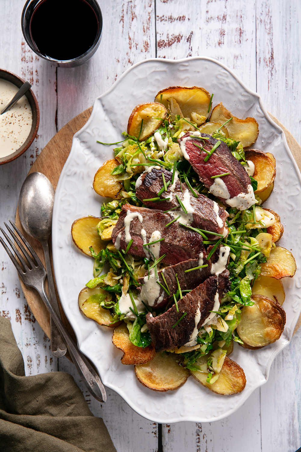 Plate up crispy potatoes, Brussels sprouts and steak. Photo / Babiche Martens