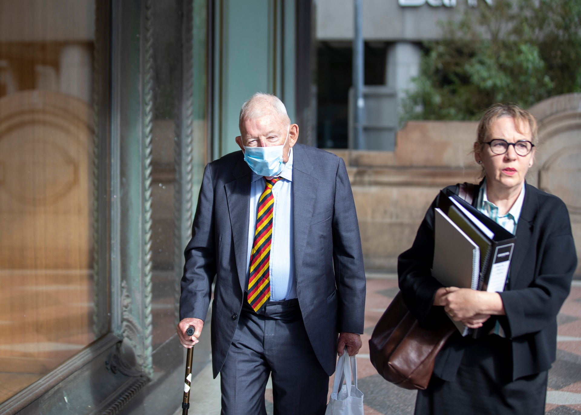 Sir Ron Brierley with lawyer Penny Musgrove leaving the Sydney court house. Photo / Liam Mendes