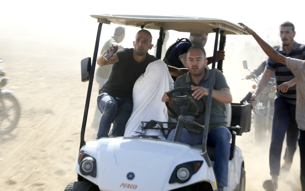 Palestinians transport a captured Israeli civilian from Kibbutz Kfar Azza into the Gaza Strip. Photo / AP
