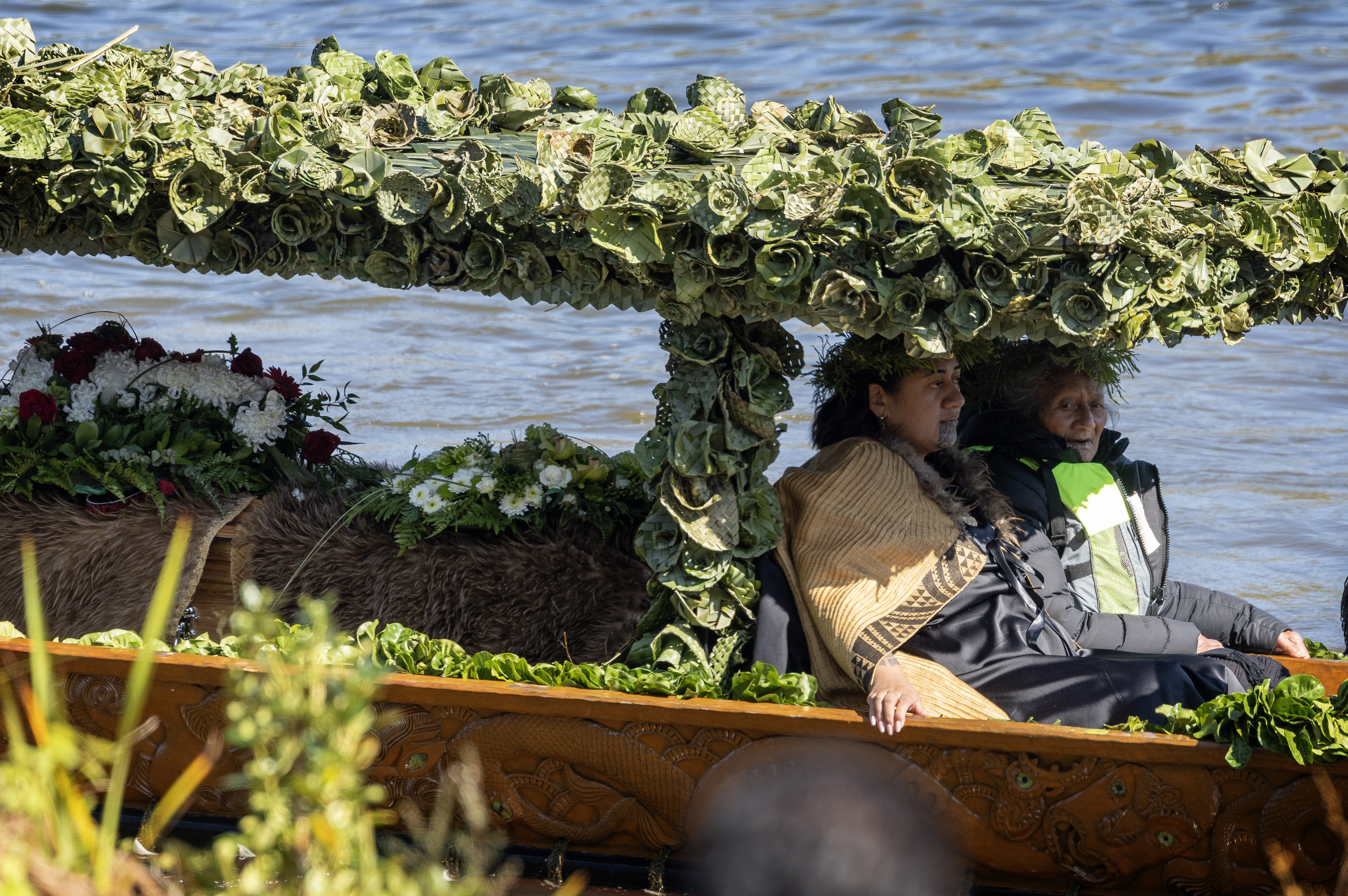 The new queen accompanies her father's coffin down the river. Photo / Mike Scott