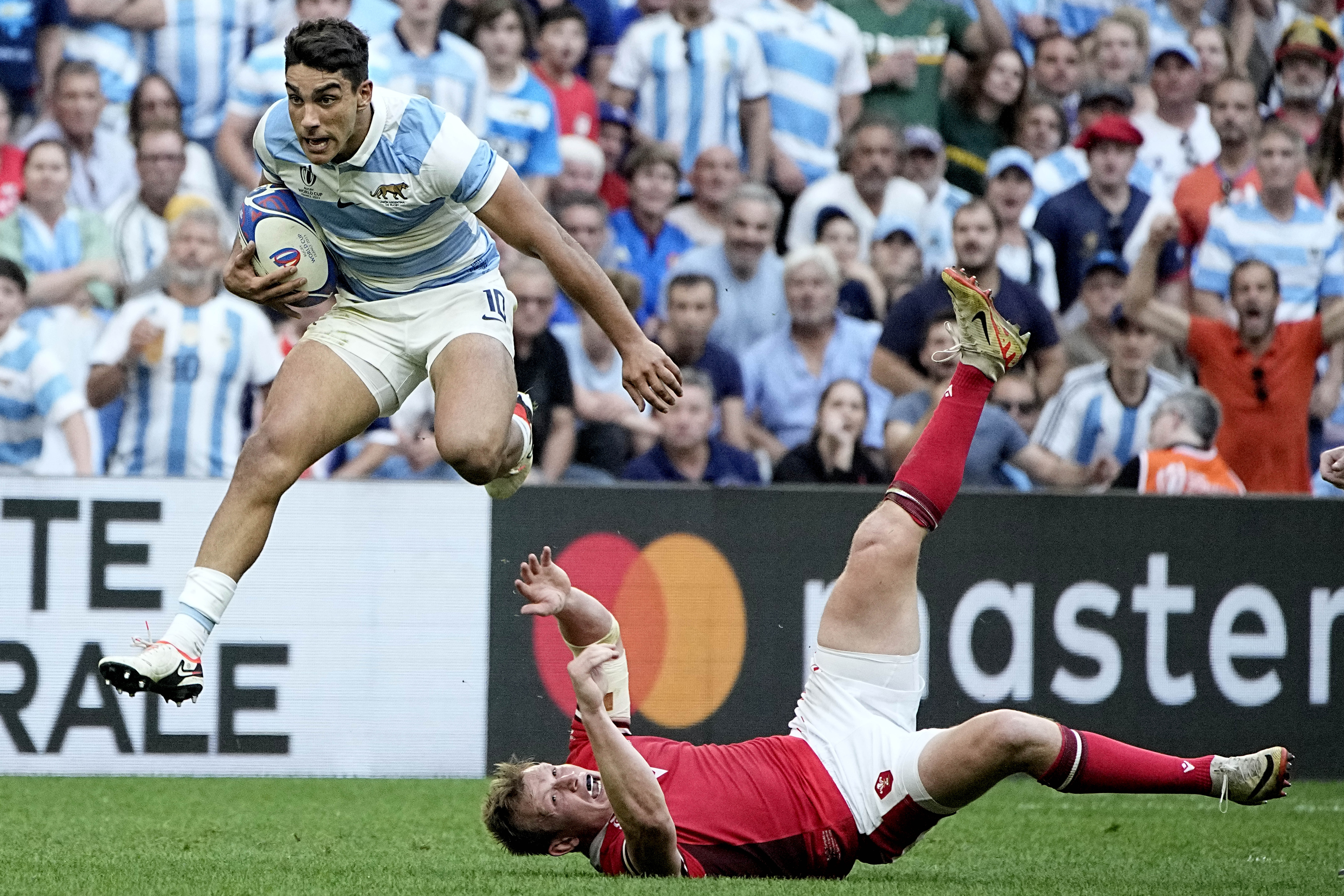 Argentina's Santiago Carreras, left, runs over Wales' Jac Morgan during the Rugby World Cup quarter-final match between Wales and Argentina. Photo / AP