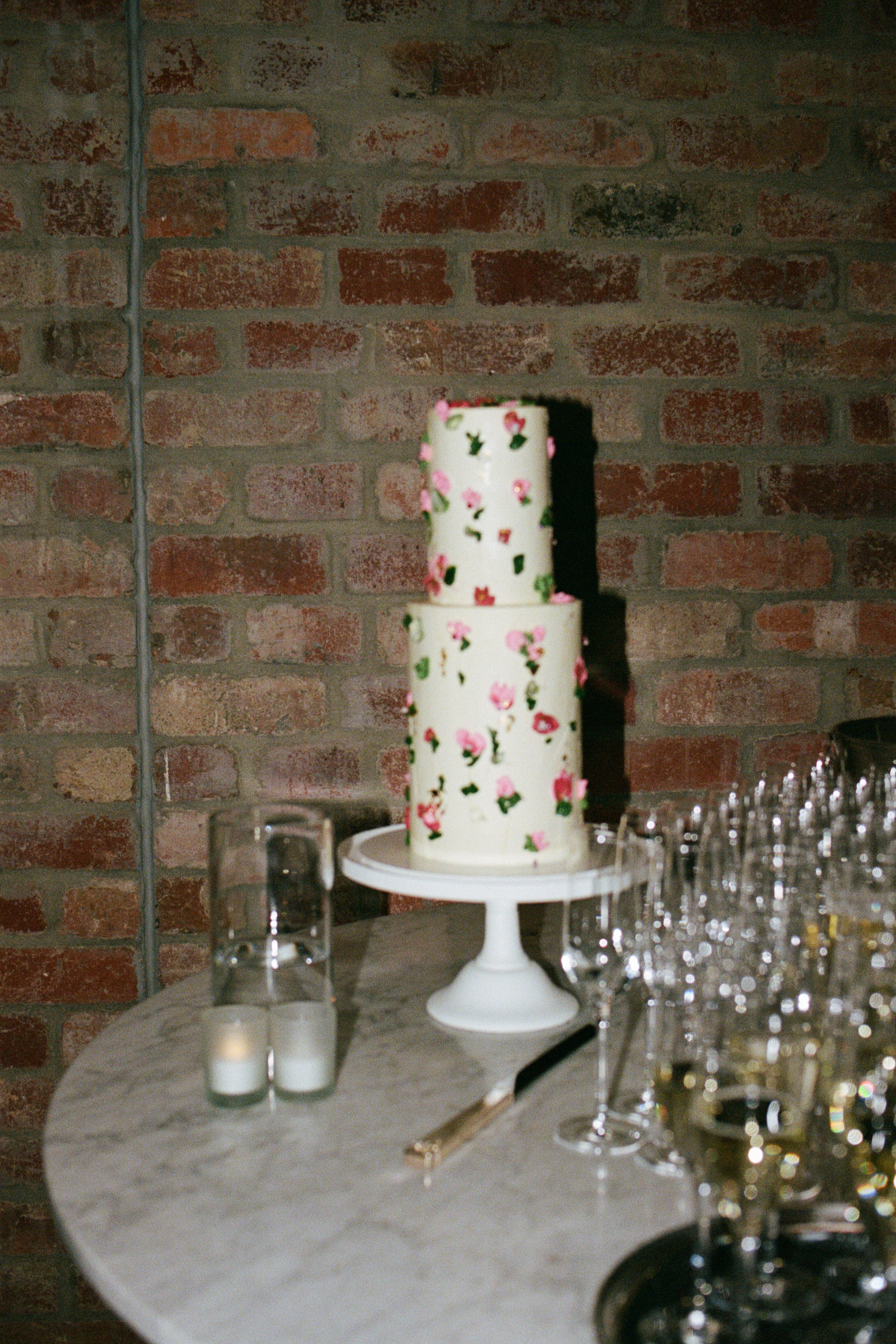 The elegant wedding cake is dressed up with pressed flowers. Photos / Kaitlyn Clark