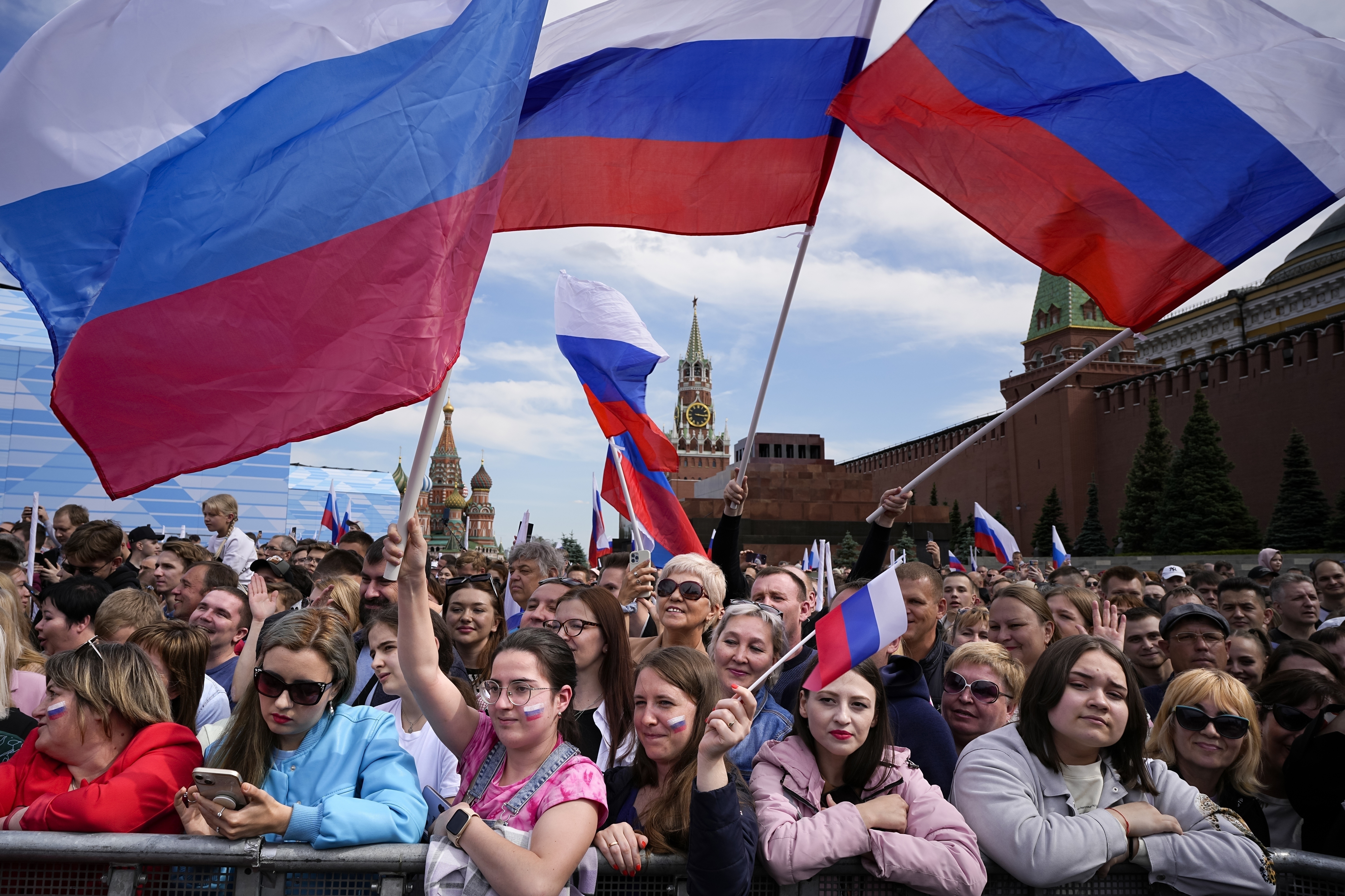 Thousands of people wave Russian national flags as they gather on Red Square to watch a concert dedicated to the Day of Russia in Moscow, Russia. Photo / AP