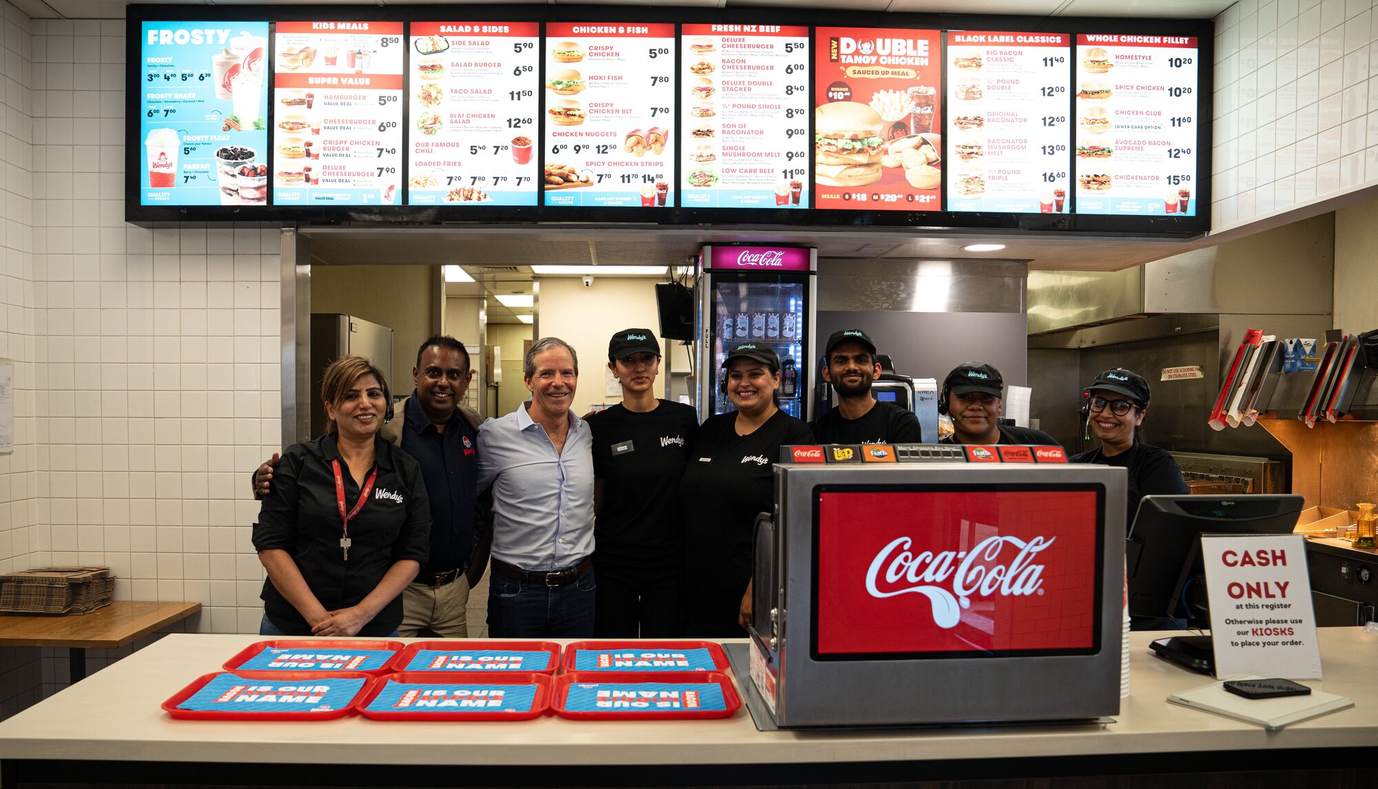 Greg Flynn, pictured with Wendy's Manukau staff members, doesn't expect to change much about the New Zealand operations, but said there is investment to come. New Zealand Herald photograph by Alyse Wright 14 April 2025.