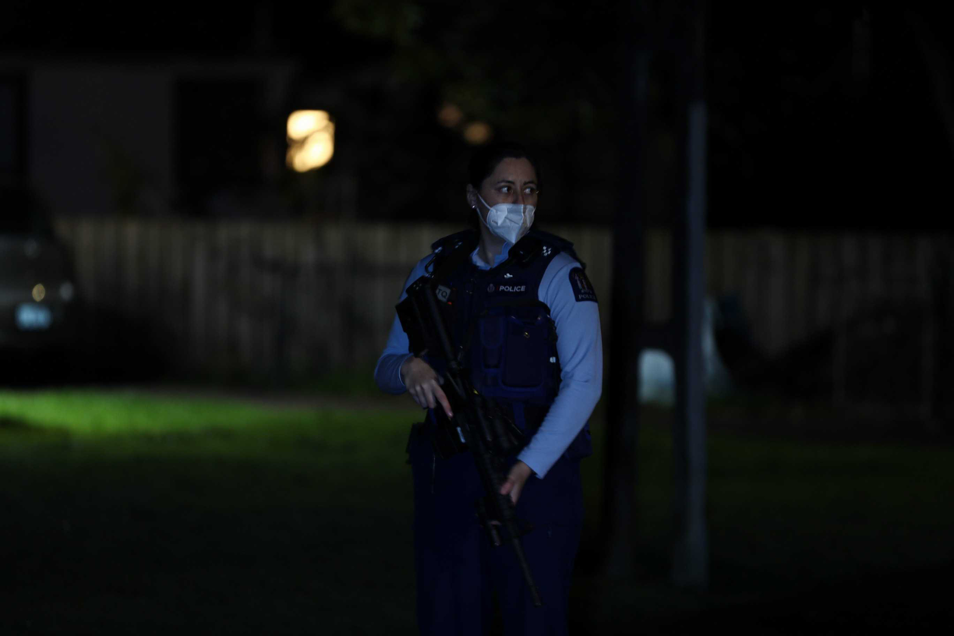 An armed police officer on Benghazi Rd in Panmure, East Auckland, following the latest gun-related incident in Auckland last night. Gunshots were heard, and one person injured. Photo / Hayden Woodward