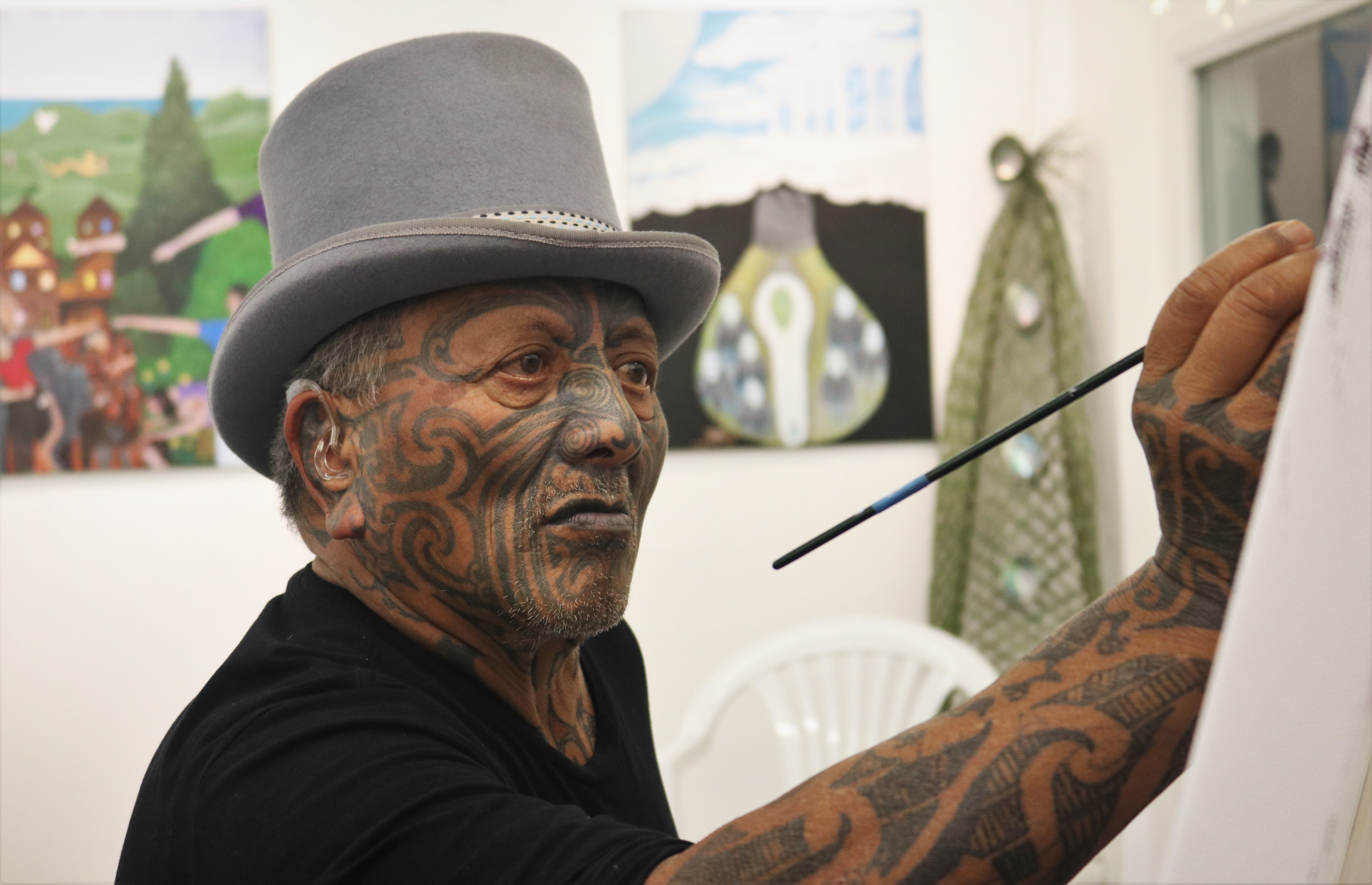 Tūhoe activist and artist Tame Iti works on a painting about returning to ancestral ways to heal from “bad colonial habits” such as methamphetamine. Photo / Peter de Graaf