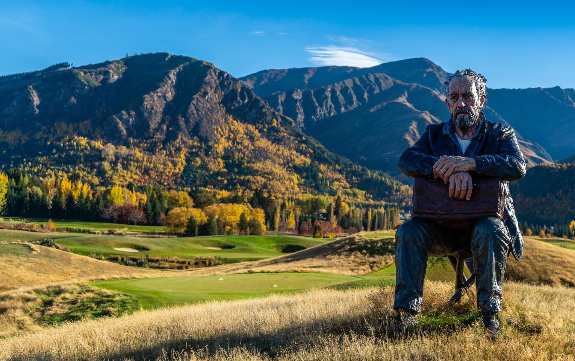The seated man bronze sculpture by British artist Sean Henry at the The Hills golf course near Arrowtown.