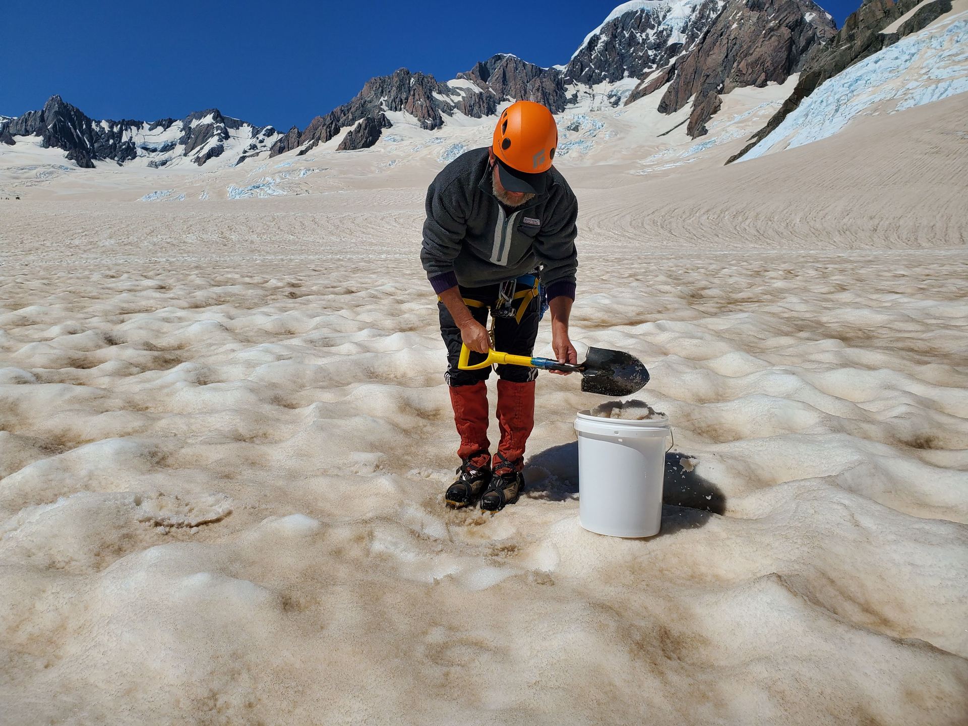 Manaaki Whenua-Landcare Research scientist Dr John Hunt collects ash-contaminated snow at Fox Glacier following Australia's unprecedented bush fires last summer. Photo / Phil Novis