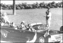 Motion picture frame showing John F Kennedy with arms raised after being hit by a bullet in 1963. 