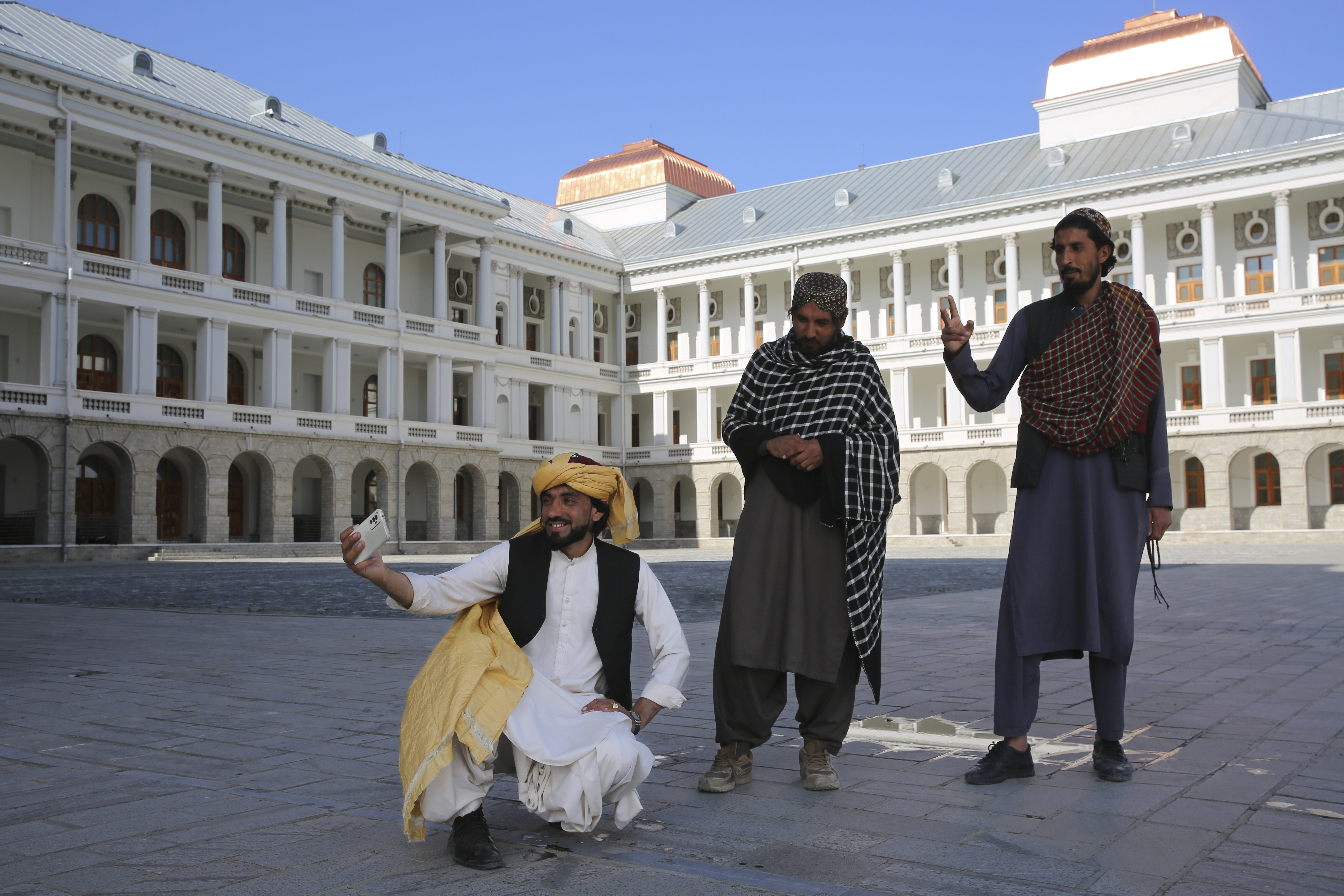 Afghans take selfies at the renovated Darul Aman Palace in Kabul, Afghanistan. Photo / AP