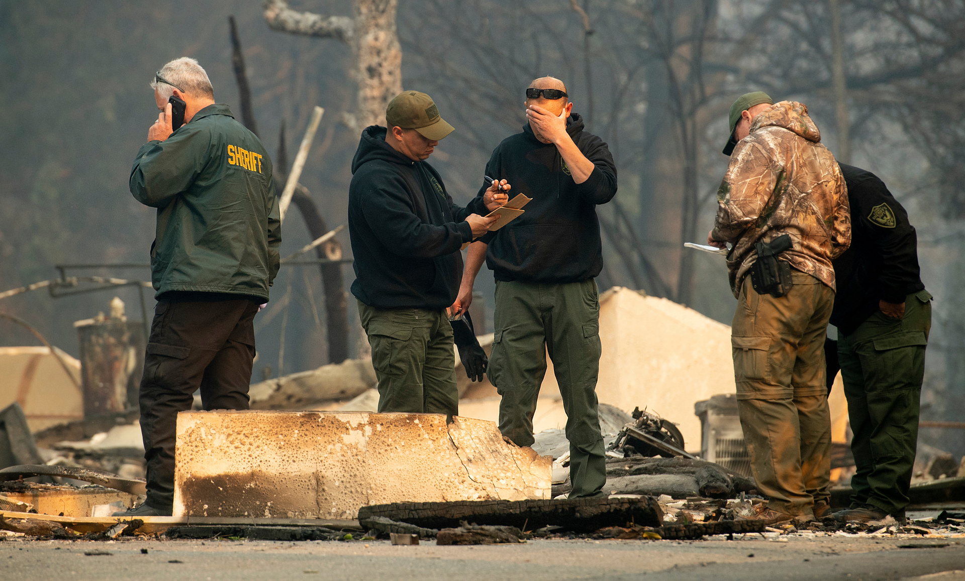 Sheriff's deputies recover the remains of Camp Fire victims. Photo / AP