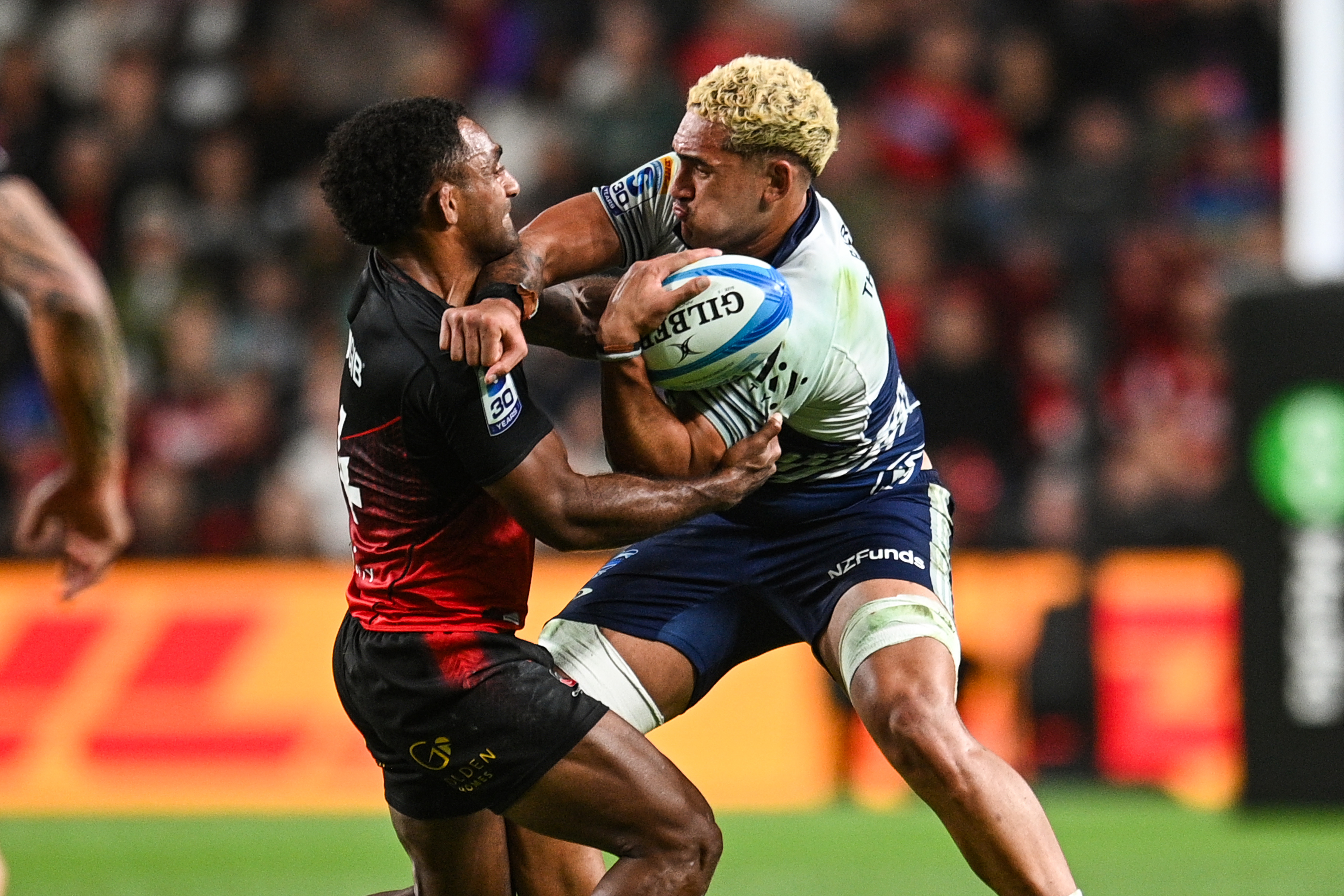 Malachi Wrampling looks to fend off Sevu Reece. Photo / Photosport