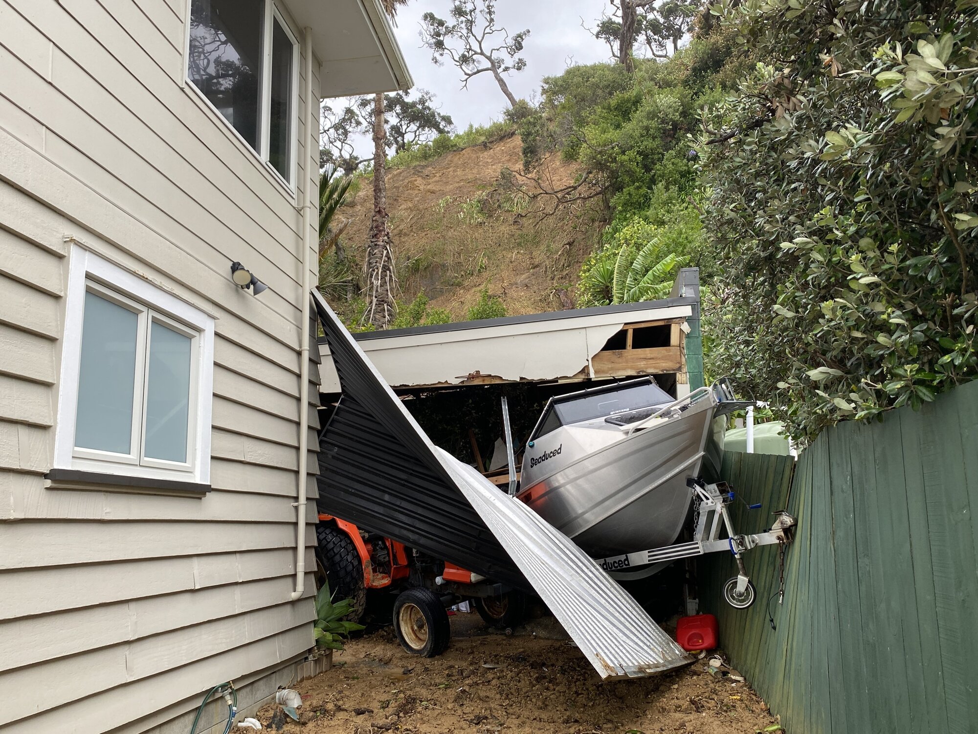 Stephen Wood says a slip filled the garage of his Ōakura holiday home with dirt and debris, forcing out his boat and tractor. Photo / Denise Piper