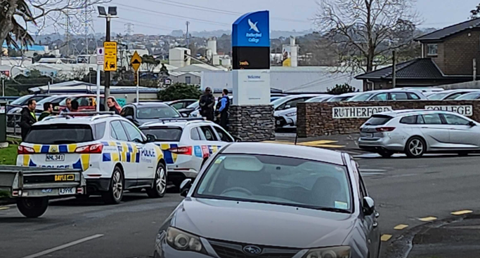 Police officers stationed outside Rutherford College, which has been placed in lockdown. Photo / Akula Sharma