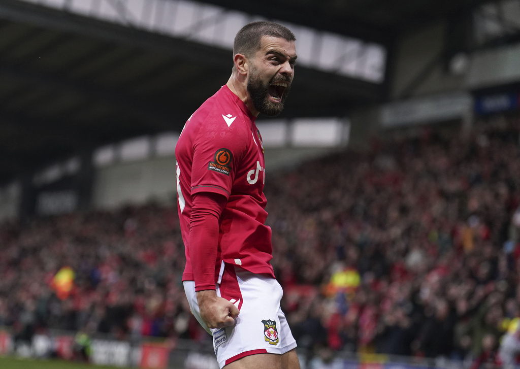 Wrexham's Elliott Lee celebrates scoring during the match against Boreham Wood. Photo / AP