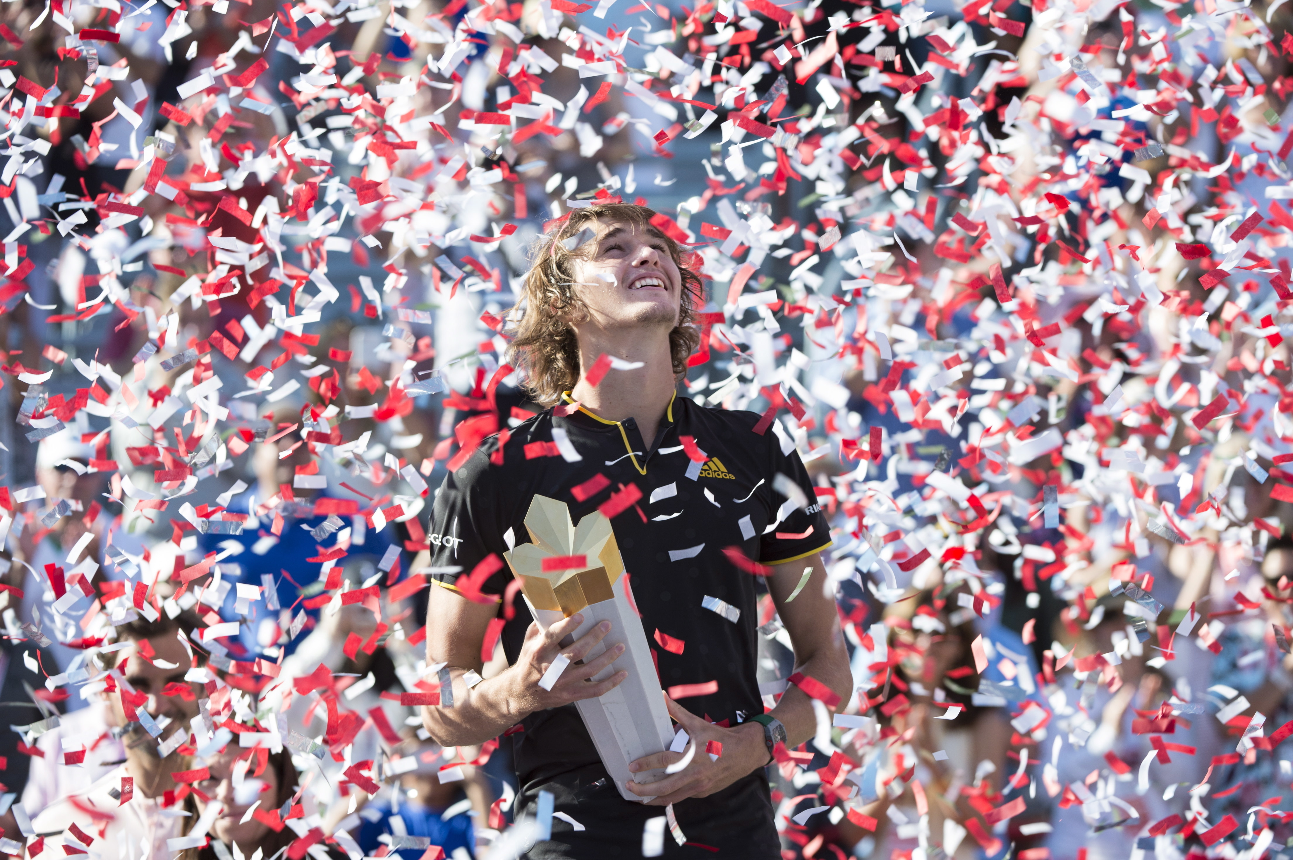 Confetti falls over Alexander Zverev, of Germany, during victory ceremonies after he defeated Roger Federer, of Switzerland, in the final at the Rogers Cup. Photo / AP
