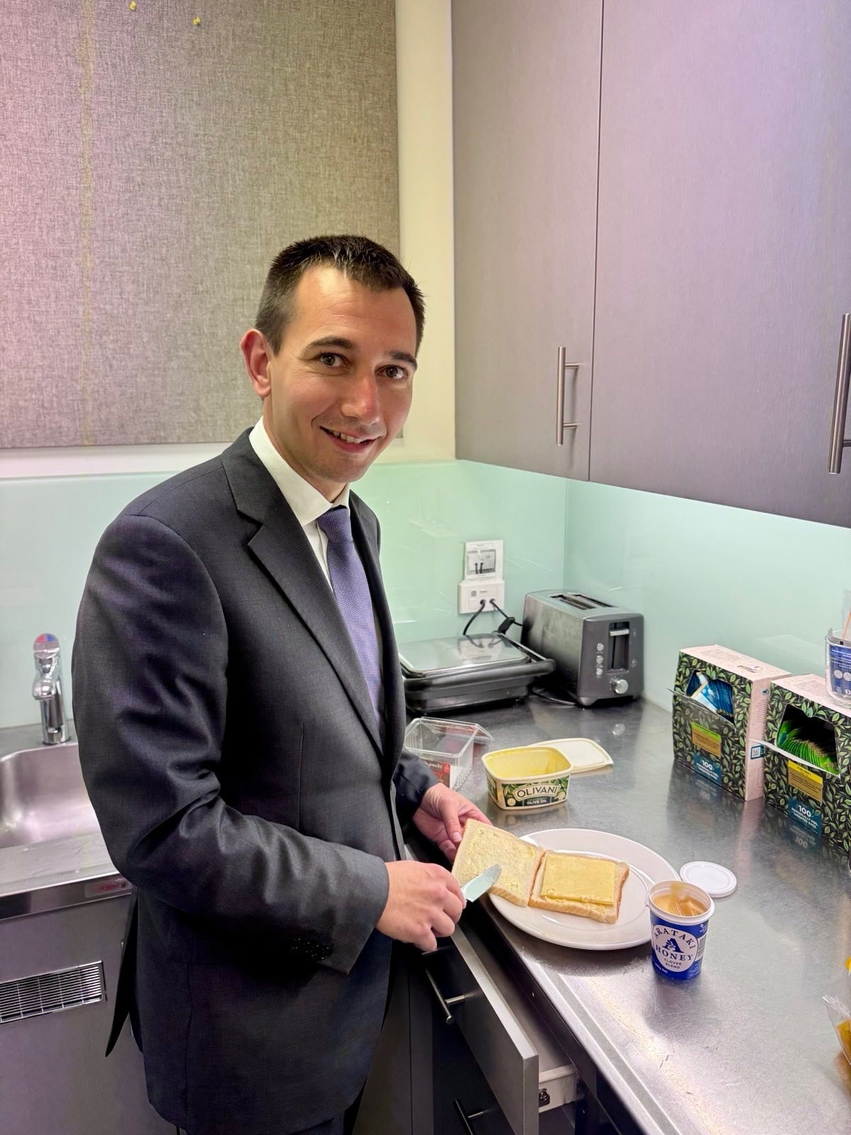 Health Minister Simeon Brown makes his cheese and honey sandwich as debate on school lunch programme rolls on. 