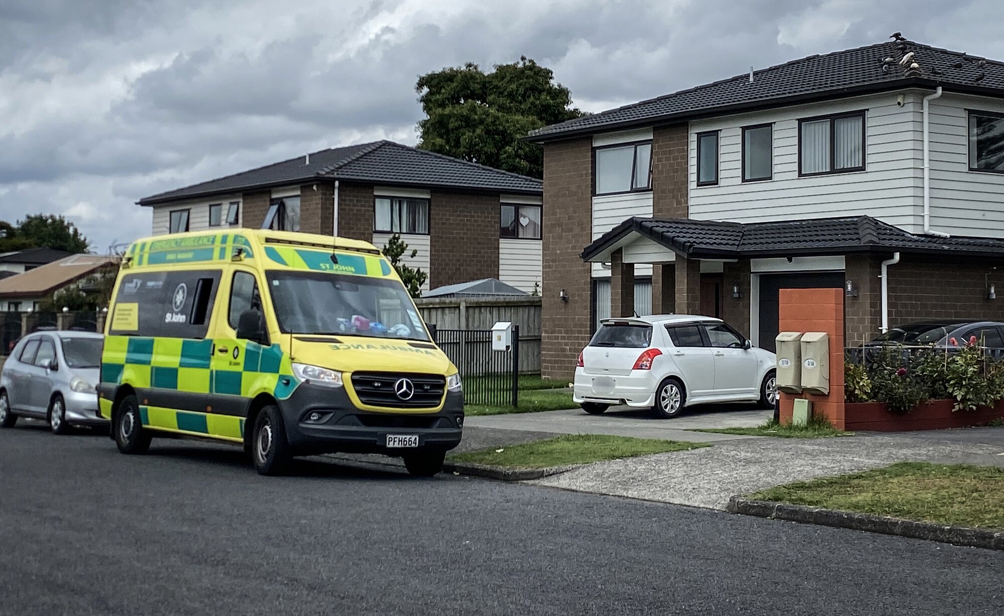 An ambulance waits outside a proprty on Sturdee Rd in Manurewa after reports of a person attacked by an animal. Photo / Cherie Howie 