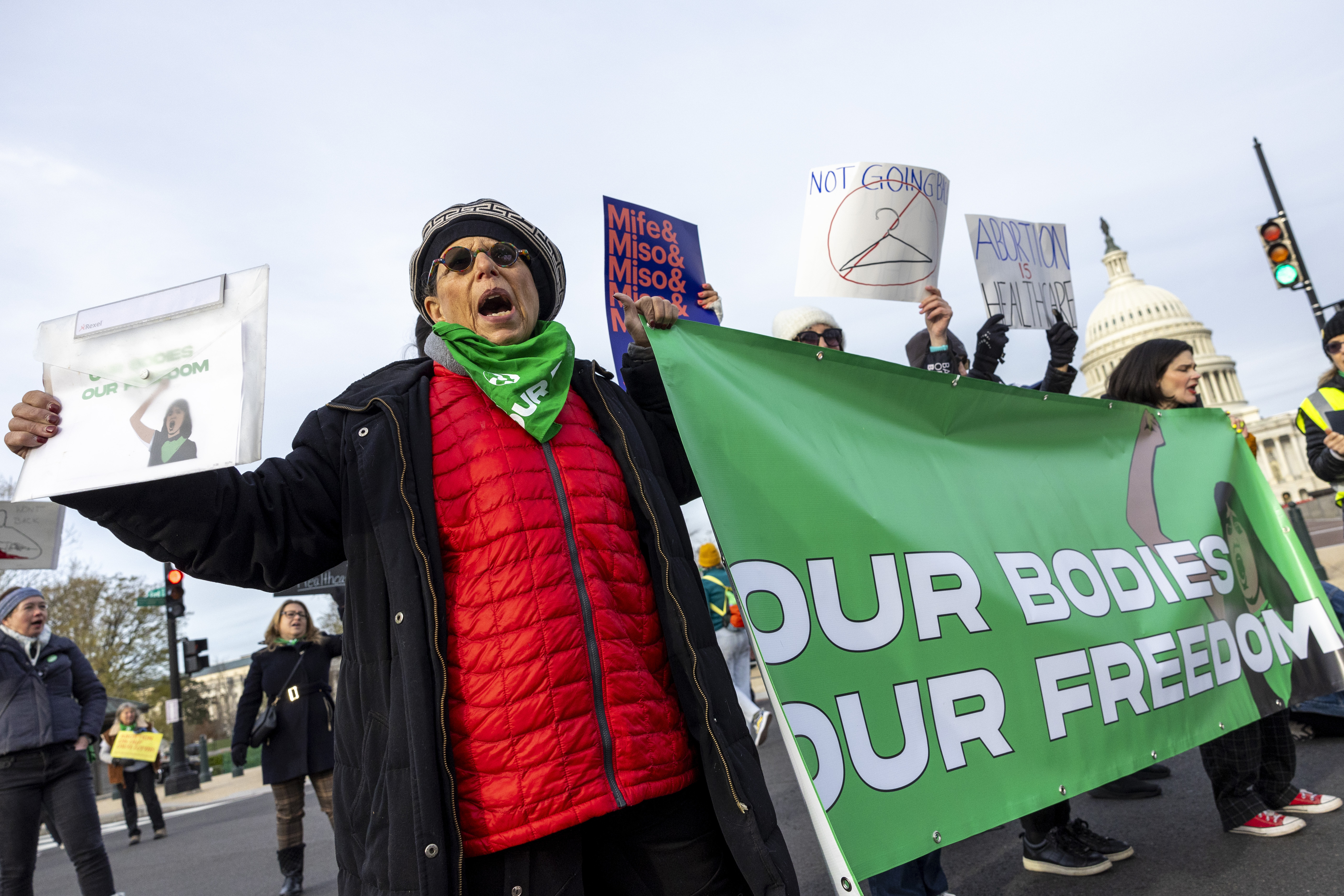 Abortion rights protestors hold up a sign at the Supreme Court. Photo / AP