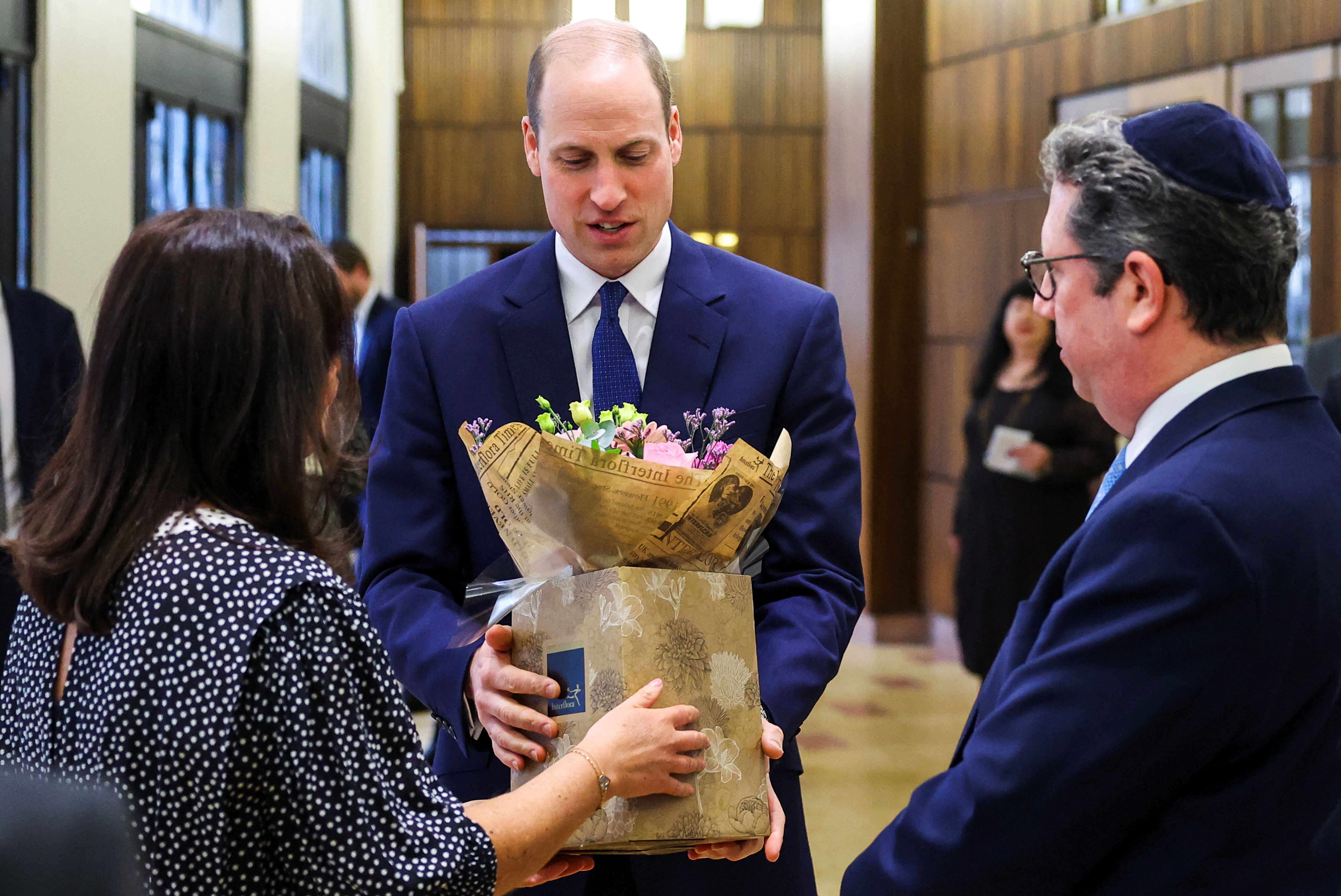 Prince William receives a bouquet of flowers for his wife during a visit to the Western Marble Arch Synagogue in London on February 29. Photo / Getty Images