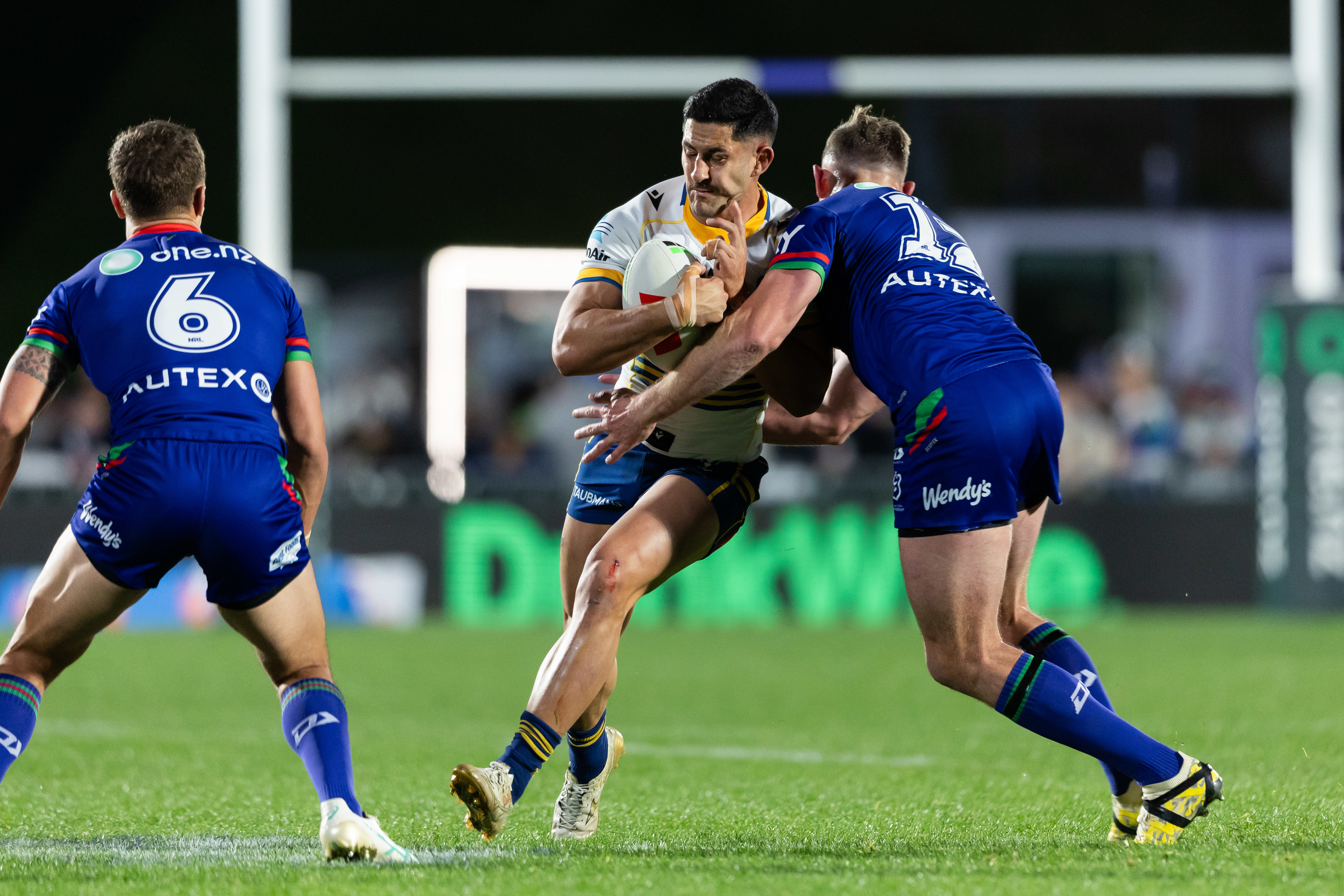 Parramatta Eels five-eighths Dylan Brown is tackled by NZ Warriors' forward Kurt Capewell during their round 22 clash. Photo / Photosport
