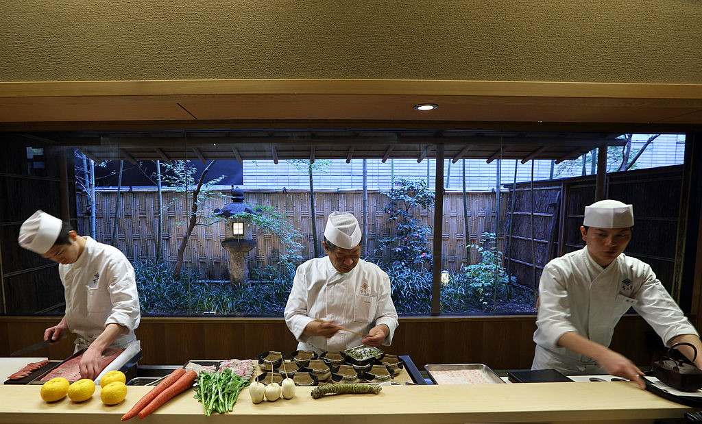 Yoshihiro Murata, centre, is master chef for Kikunoi restaurant and chairman of the Japanese Culinary Academy. Photo / Getty Images