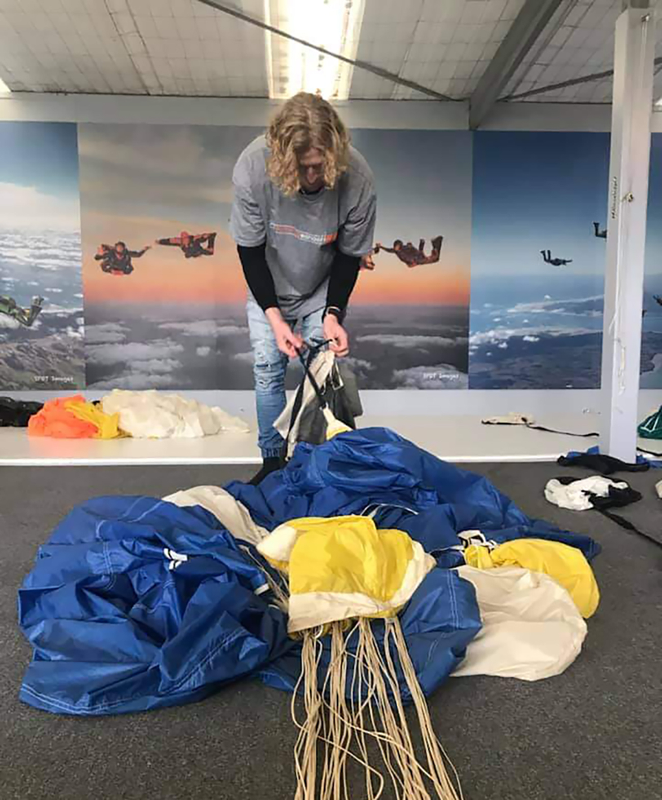 Skydiving graduate Theo Williams, seen here packing a parachute, was meticulous about safety, his parents say. Photo / Supplied