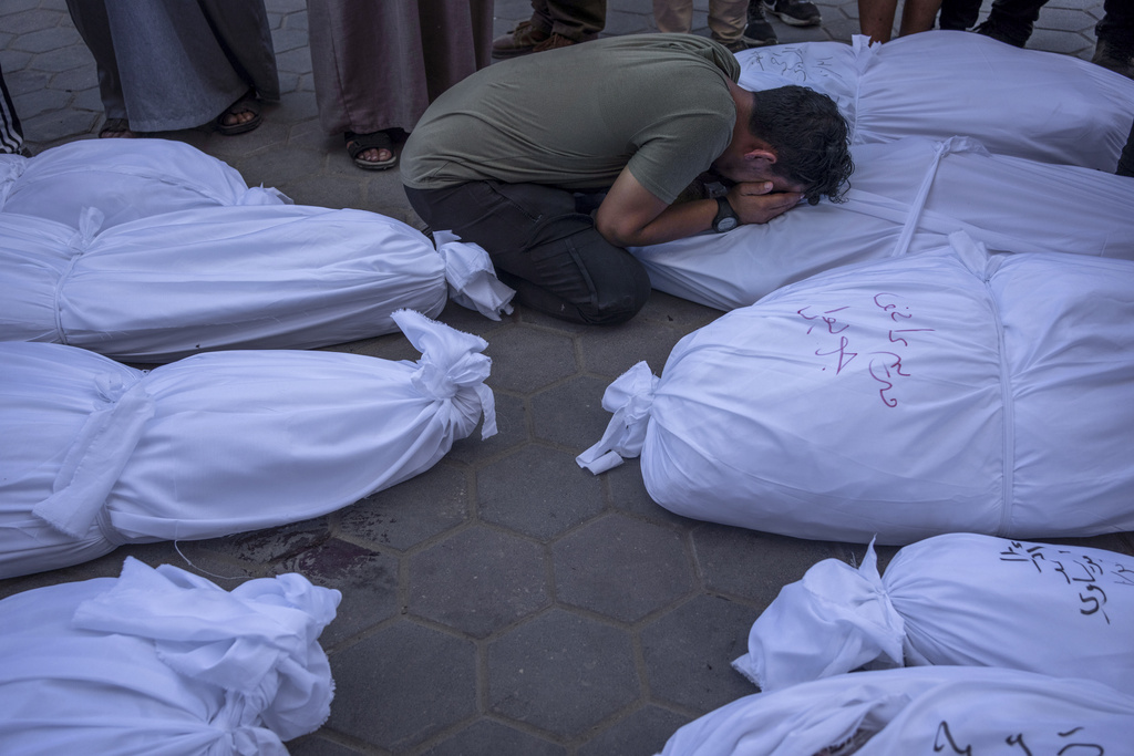 Palestinians mourn relatives killed in the Israeli bombardment of the Gaza Strip, in front of the morgue in Deir al Balah on October 31. Photo / AP