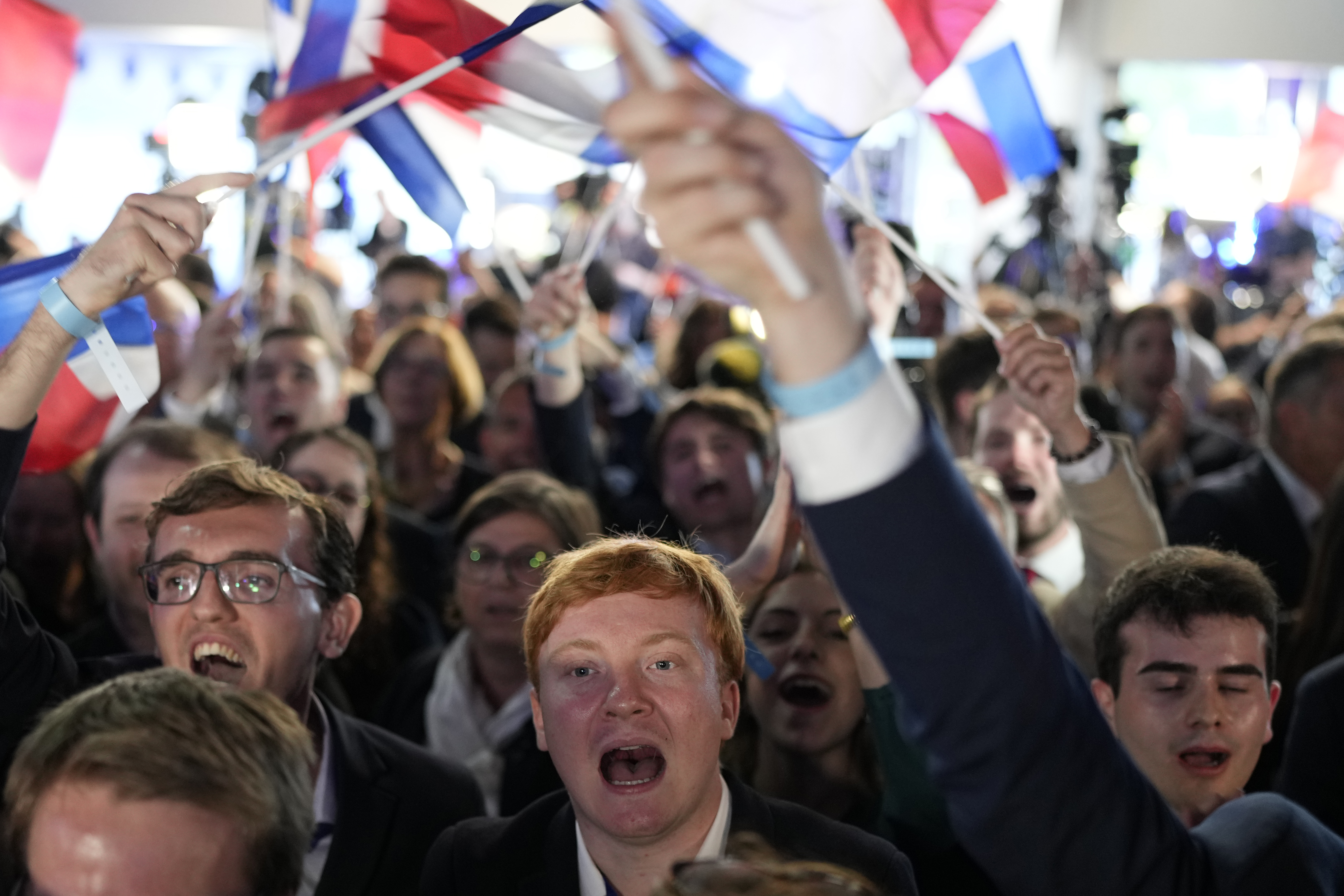 Supporters of French far-right National Rally react at the party election night headquarters. Photo / AP
