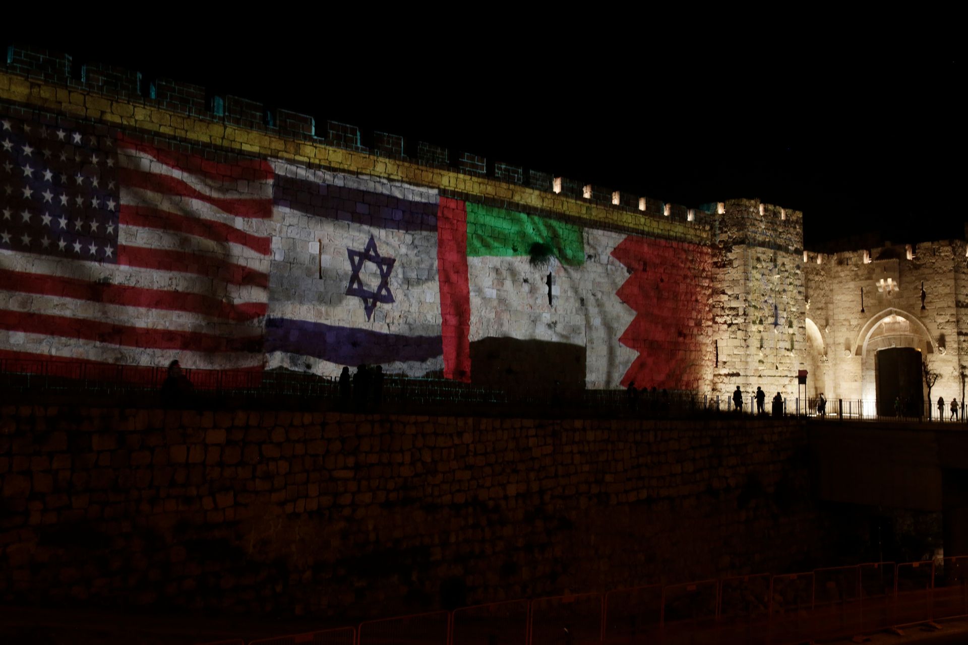 Representations of the US, Israeli, Emirati and Bahraini flags are projected onto a wall of Jerusalem's Old City, marking the day of a signing ceremony in Washington. Photo / AP
