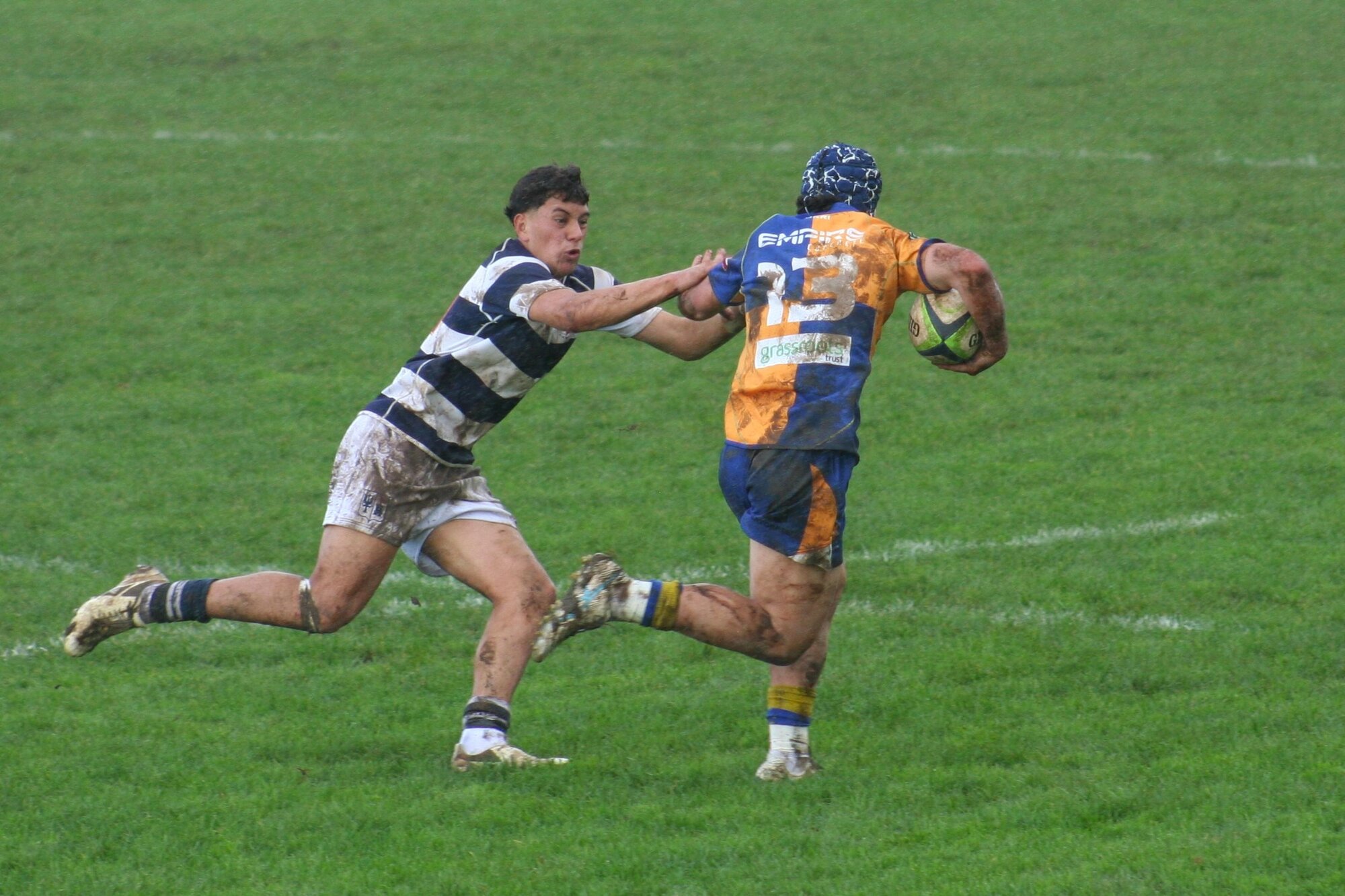 Charlie Robbie (Palmerston North BHS) tackles Ollie Penfold (St John's, Hamilton). Photo / Bruce Holloway