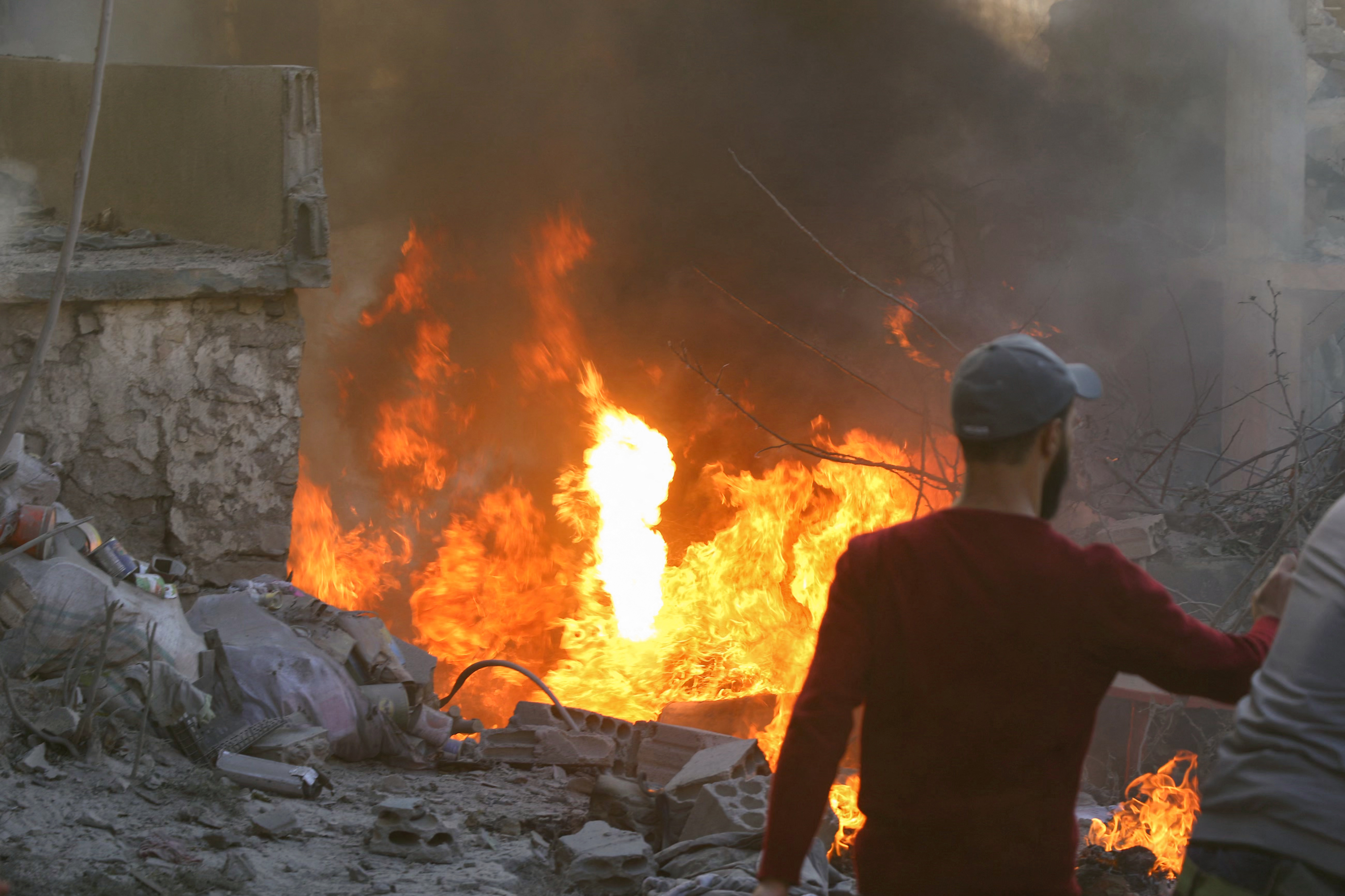 People and rescuers tried to put out a fire at the site of an Israeli airstrike that targeted a densely populated neighbourhood in Lebanon's eastern city of Baalbek on November 6, 2024. Photo / AFP
