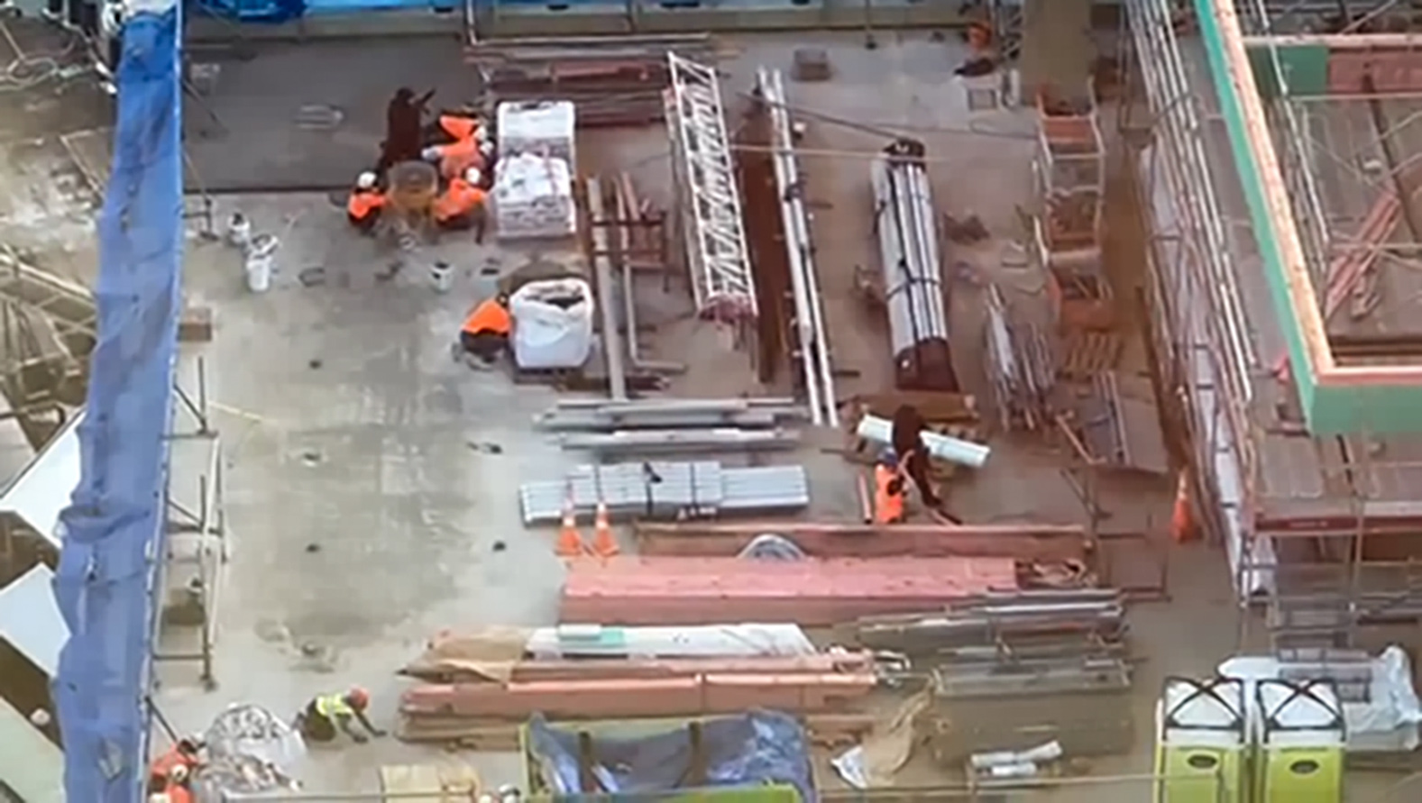 Construction workers on the roof taking cover as the shooting unfolds.