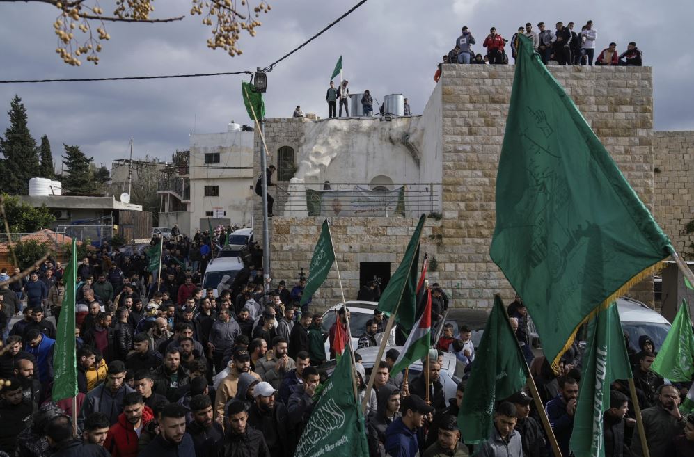 Palestinian demonstrators wave Hamas and their national flags during a protest against the killing of top Hamas official Saleh Arouri in Beirut, in the West Bank town of Arura. Photo / AP