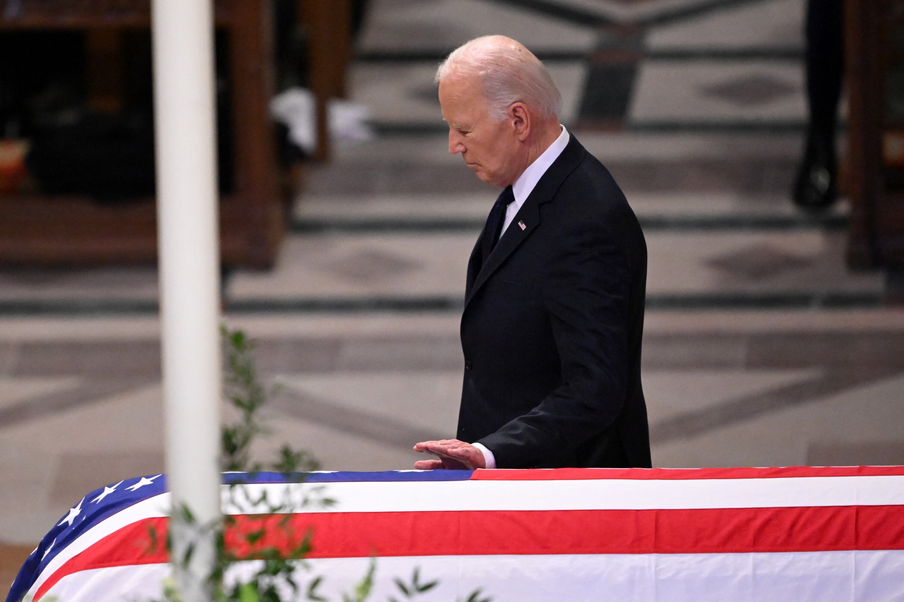 US President Joe Biden touches the casket after delivering the eulogy at the State Funeral Service for former US President Jimmy Carter at the Washington National Cathedral in Washington, DC. Photo / AFP