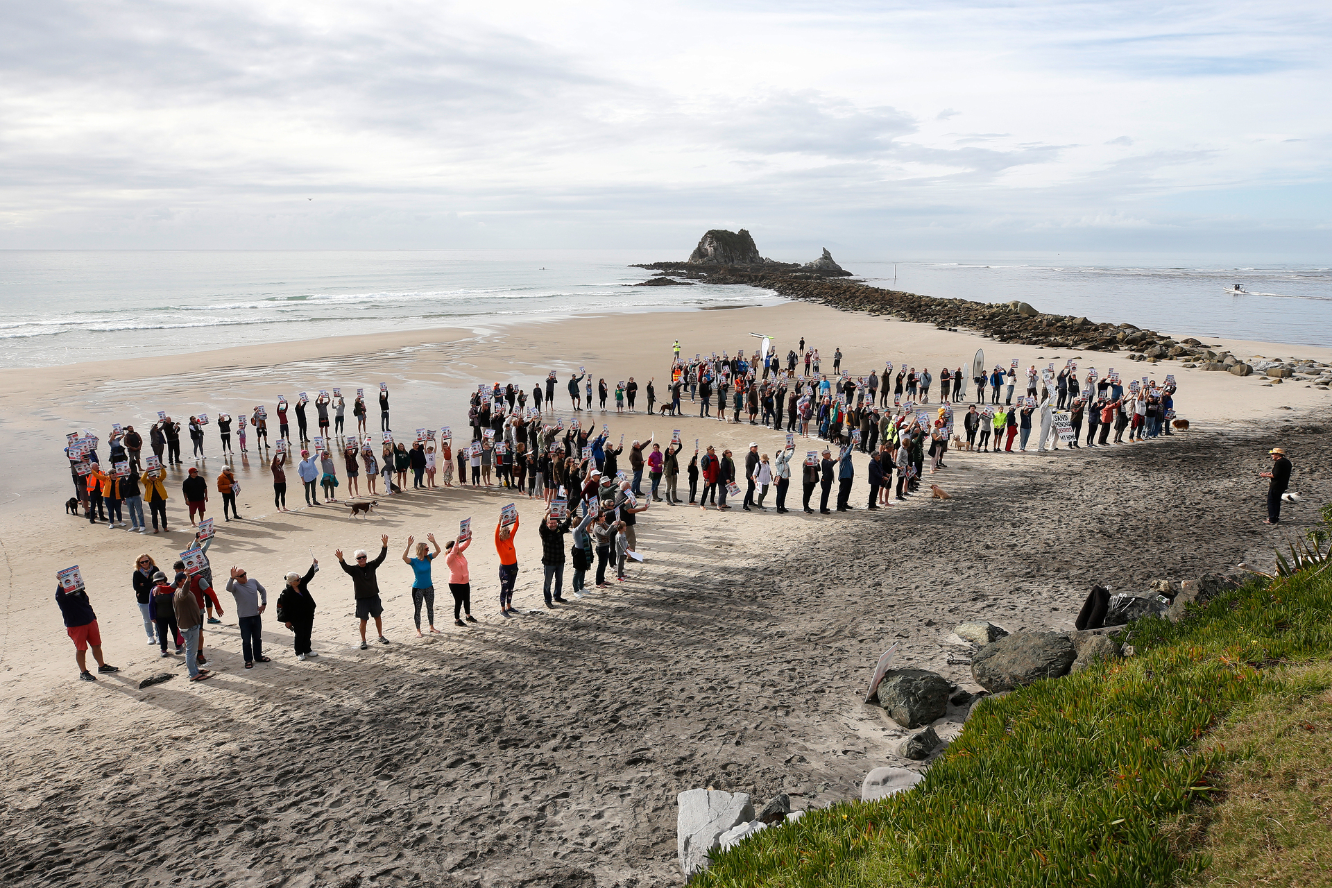 A group of around 300 Save Our Sand protesters spells out S.O.S on the beach. Photo / Michael Cunningham