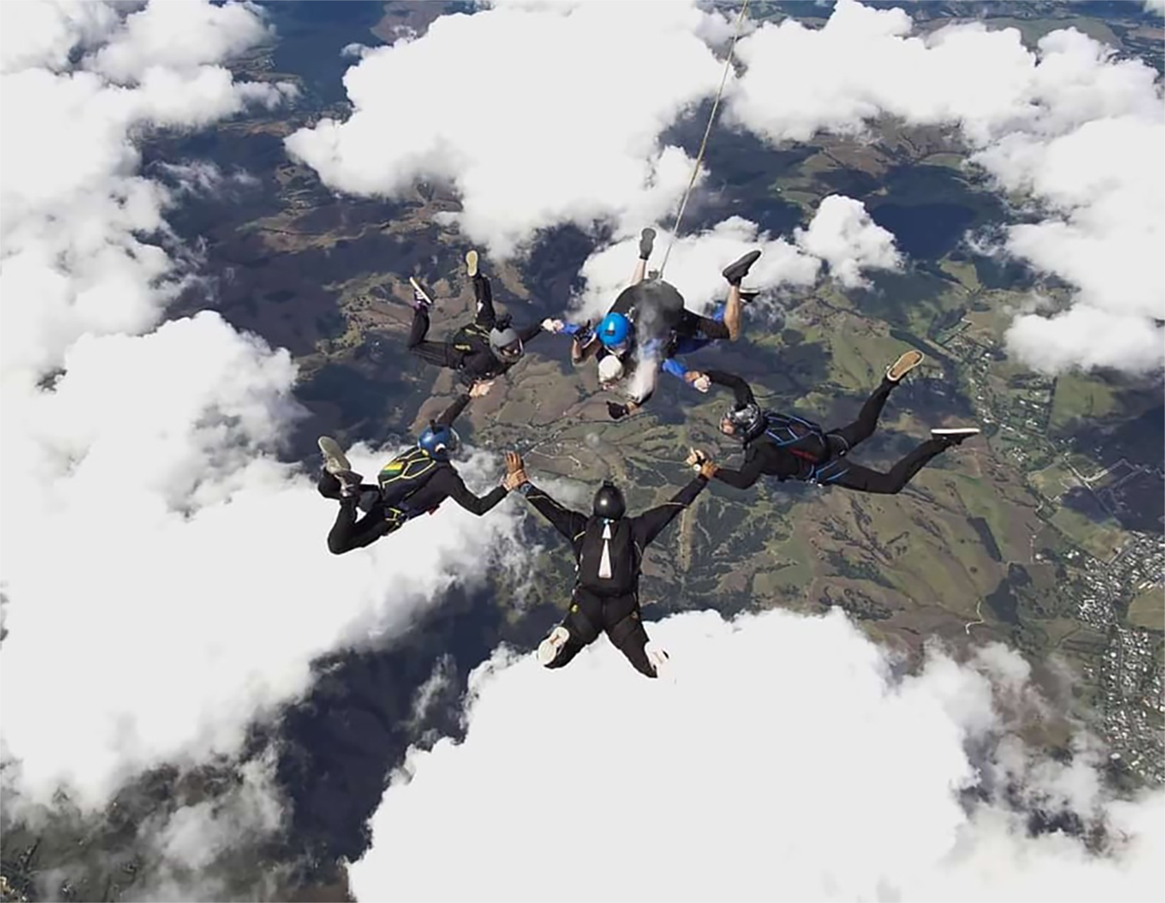Abby Creane and friends of her brother, Jack, release the dead skydiver's ashes during a tribute jump over Parakai in March 2019. Photo / Supplied