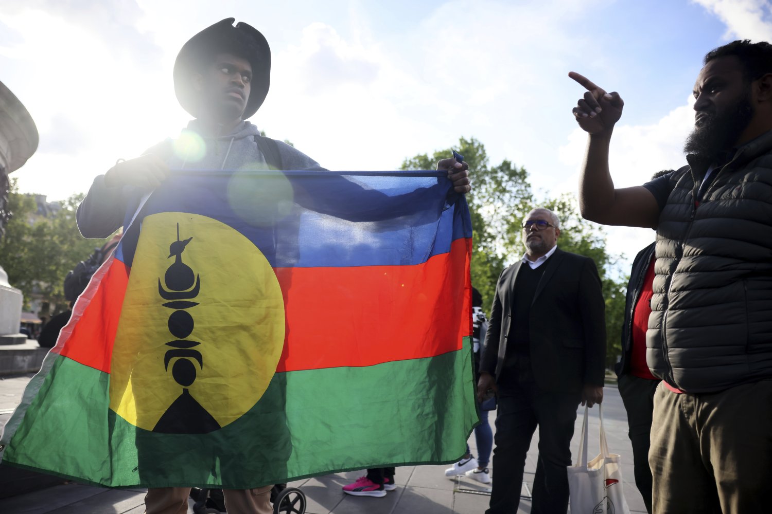 Demonstrators hold Kanak and Socialist National Liberation Front flags during a gathering in Paris on May 16. Photo / AP