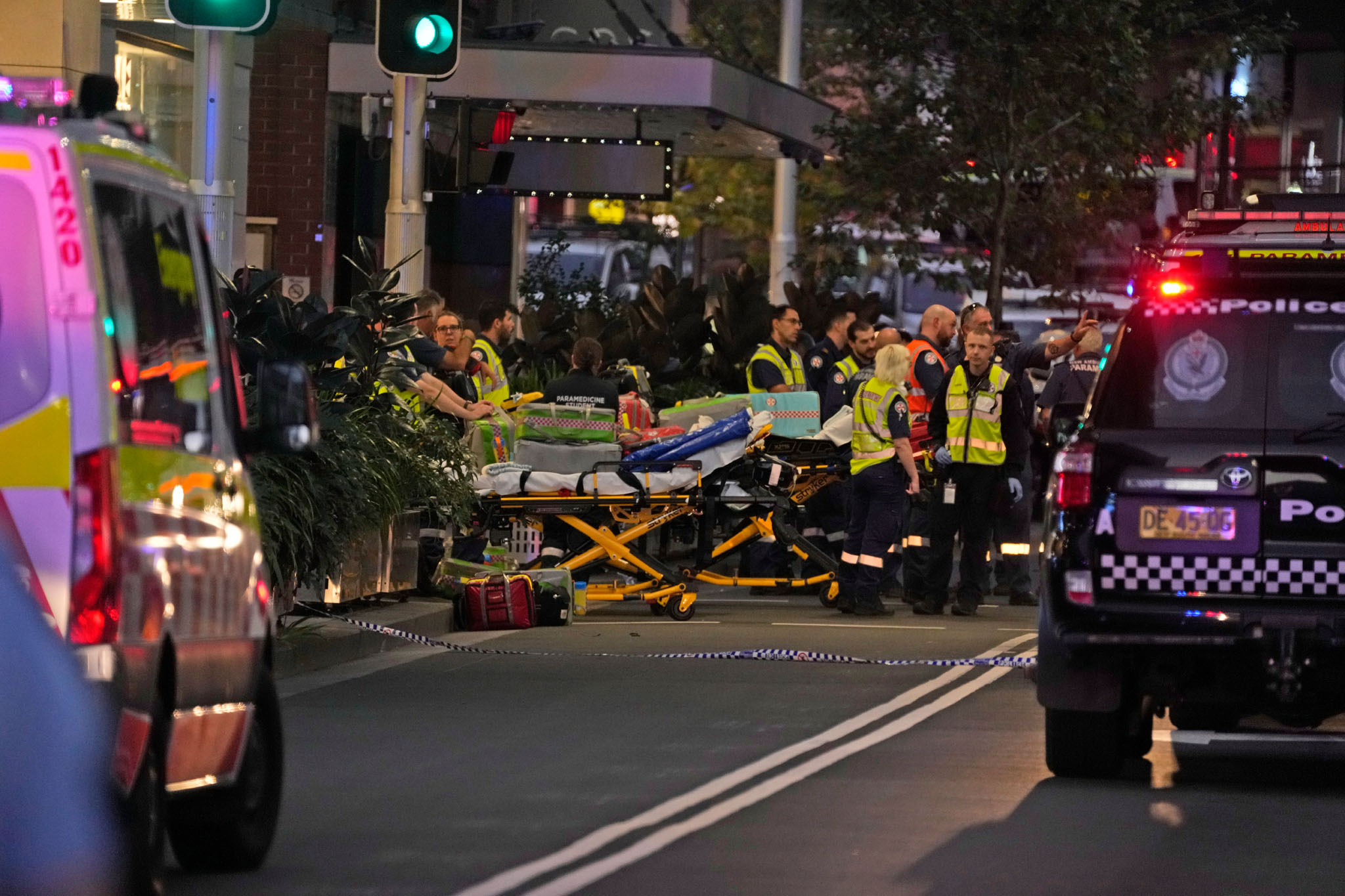 Emergency officers stand by with stretchers outside Westfield Shopping Centre where multiple people were stabbed in Sydney. Photo / AP